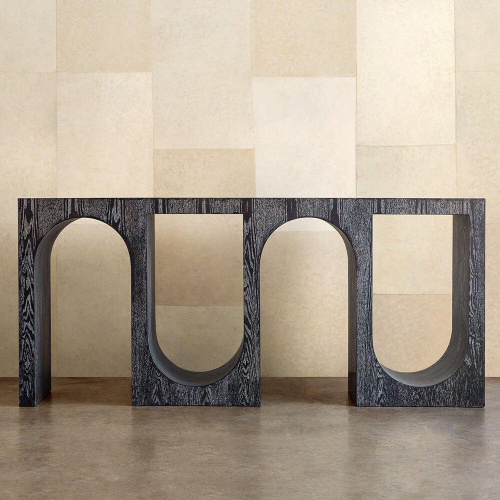 With its repetitive arches and monolithic scale, the Roxbury Long Console celebrates a minimal, stylistic nod to classical architecture and form. This console features a lightly wire-brushed wooden frame that is available in cerused wenge and