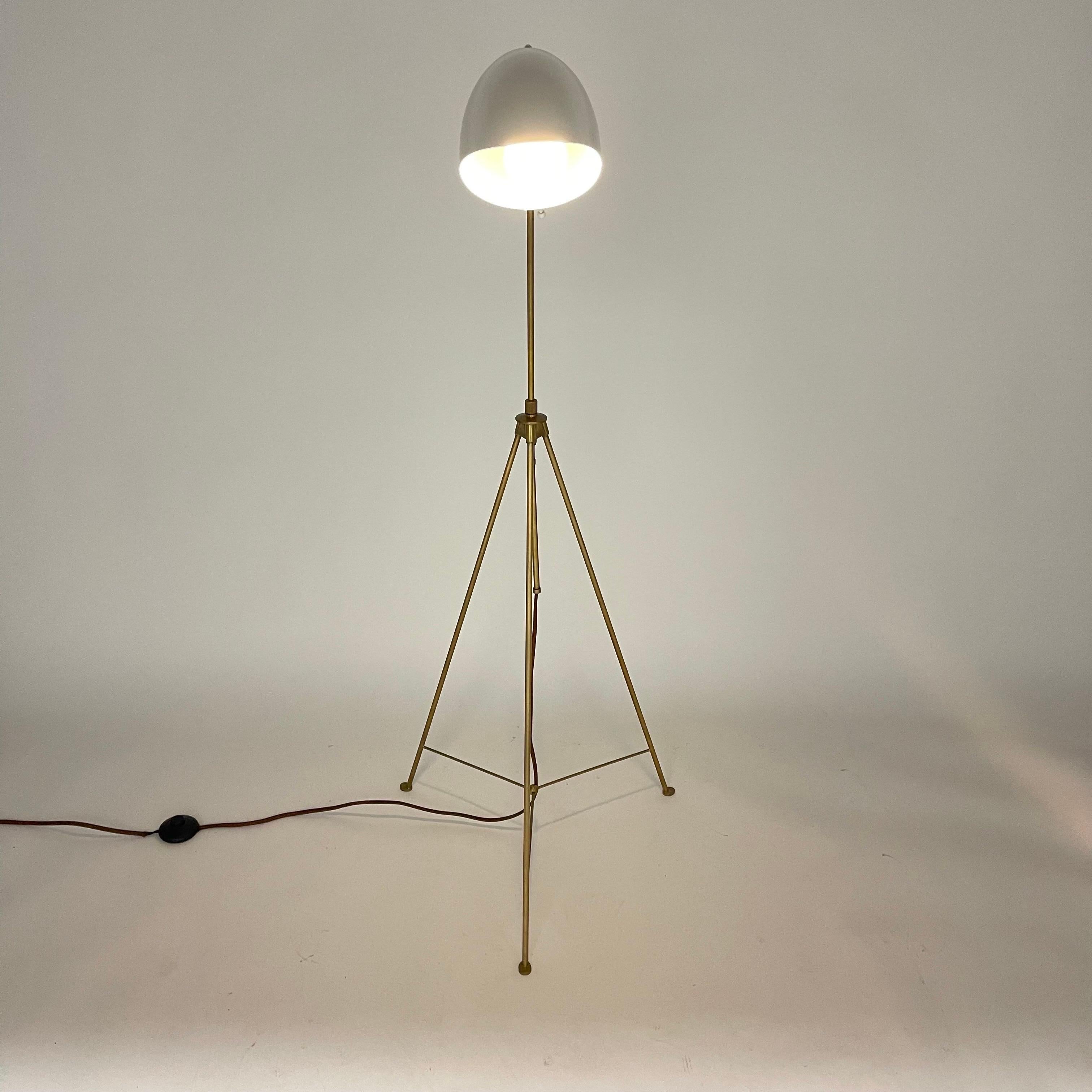 Versatile adjustable floor lamp, rendered in bronze height adjusting stem and legs and a white enamel.  Designed by Kelly Wearstler, USA 2015.