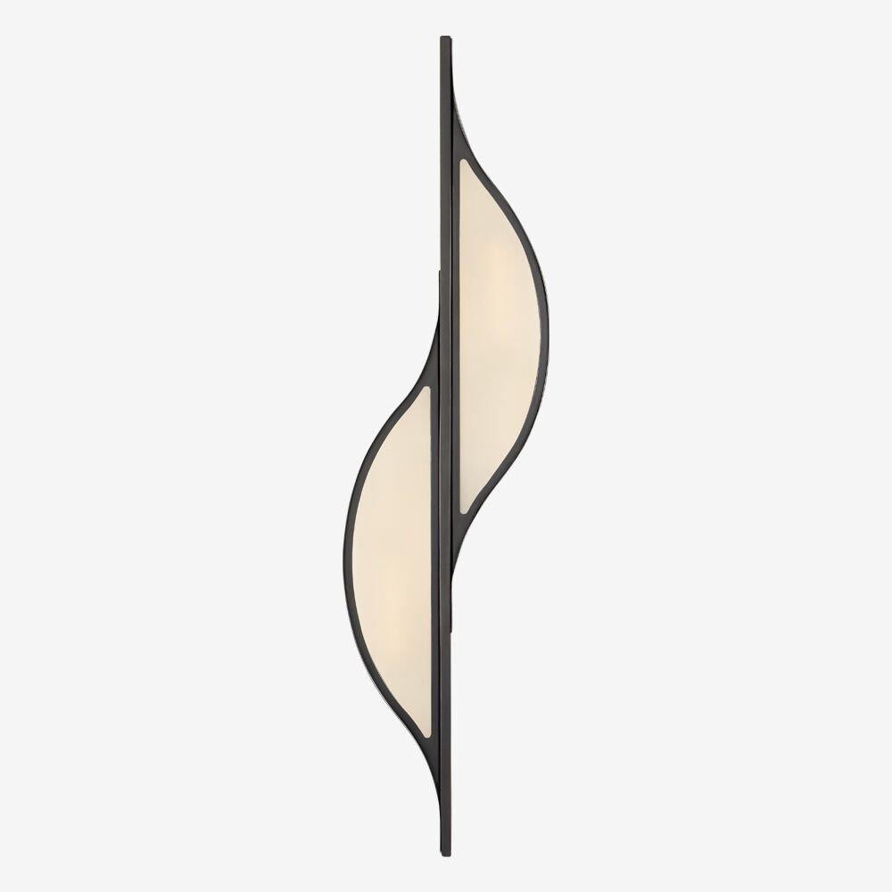 The Avant large curved sconce emanates a simplistic modernism inspired by the pure interaction between line and curve. This sconce is available in antique brass, bronze or polished nickel with frosted glass and is rated for use in damp