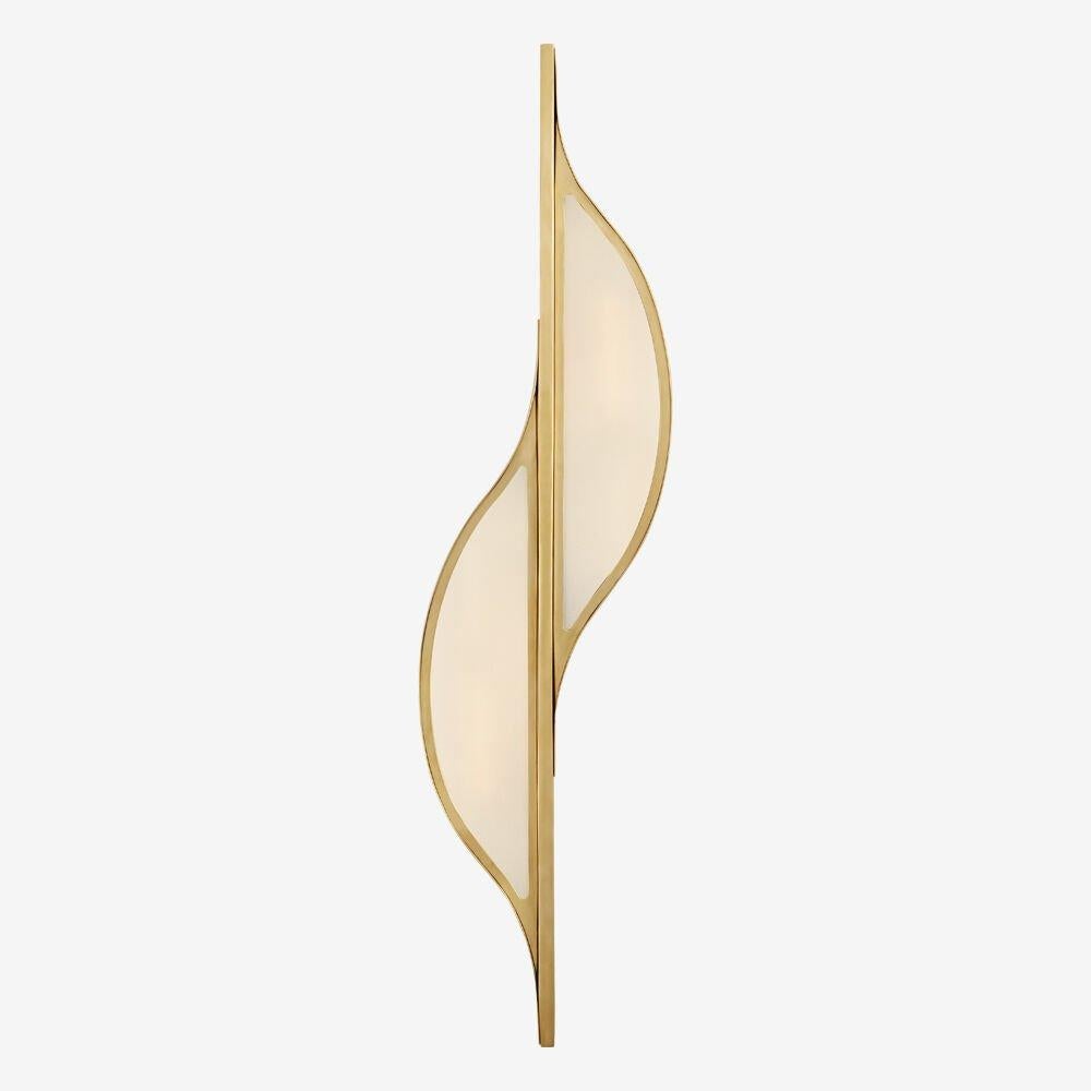 The Avant large curved sconce emanates a simplistic modernism inspired by the pure interaction between line and curve. This sconce is available in antique brass, bronze or polished nickel with frosted glass and is rated for use in damp