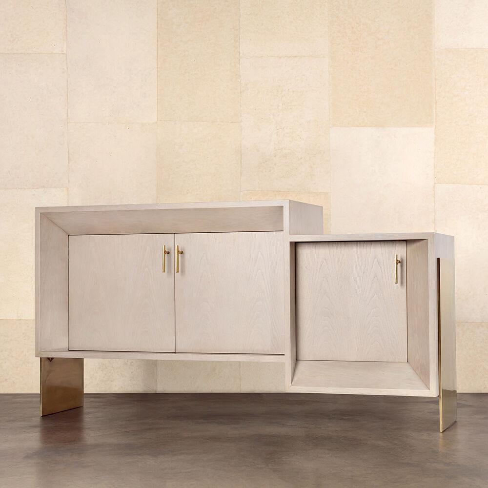 With its monolithic and unique form, the Davana Credenza emphasizes a truly architectural take on perspective and three-dimensional geometry. This credenza features solid Brass sheet legs, custom hand-sculpted Brass door pulls and a body of