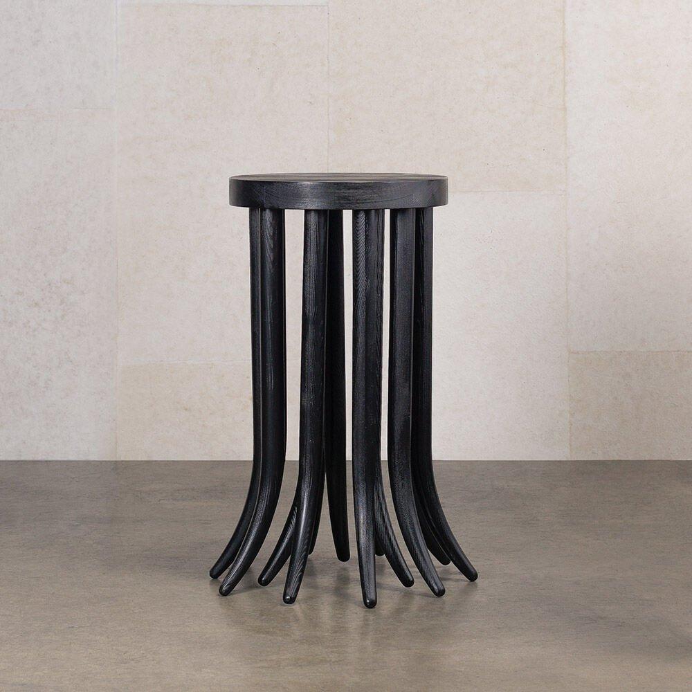 Organic and sculptural, the leggy Drexel side table highlights the playful dichotomy between art and function. This petite side table features Douglas Fir in an ebonized finish that is sandblasted to enhance the dynamic grain patterns of the wood.