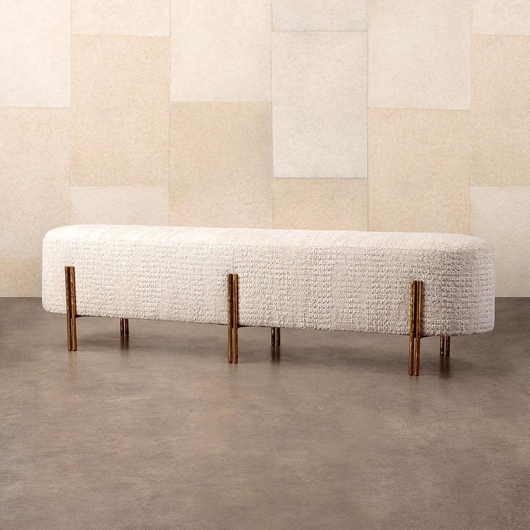This bench features solid cast brass legs with an artisanal hand that’s been finished in a lightly polished burnished brass patina. With a form that is both simple and bold, the Melange Bench is the paradigm in nuanced modern design. The upholstered