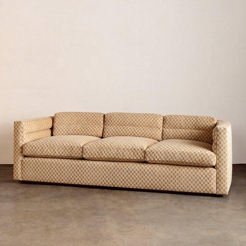 This classic track-arm sofa with a softly curved back features a signature tailored channel detail running throughout. Three loose back cushion and three seat cushions use a mix of duck down and feather for longevity and ultimate comfort. The legs