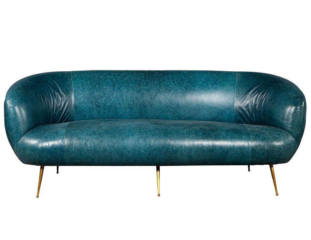 Kelly Wearstler modern leather settee sofa. Featuring distressed turquoise leather and burnished bronze accent feet.
Price includes complimentary curb side delivery to the continental USA.
