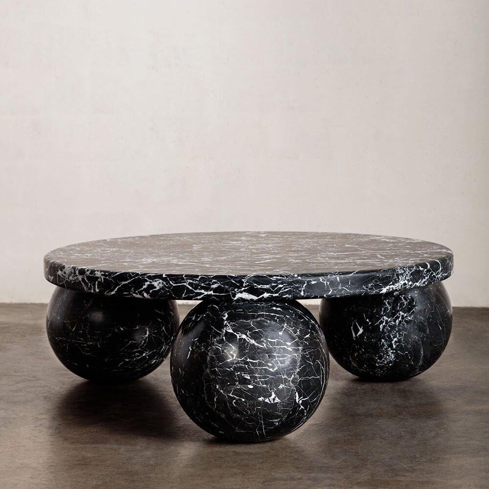 Hand carved from solid stone, the morro coffee table exemplifies modernity through geometric simplicity and form. The sculptural 3-sphere base and substantial top are each composed of solid nero marquina with a honed finish that enhances the