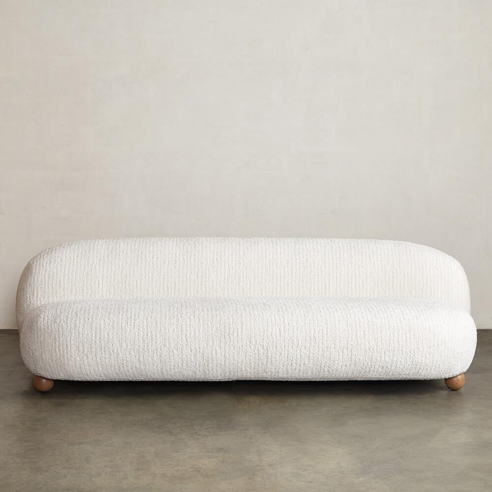 Intersecting spherical forms upholstered in boucle fabric, the Morro Sofa is a playful, yet sophisticated seating option.