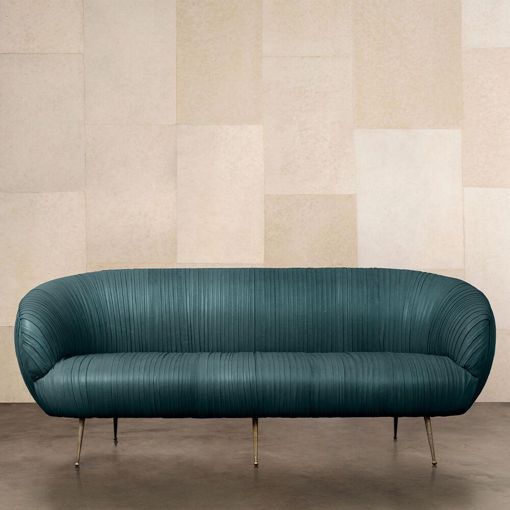 The delicate lines of this sofa are created by a signature ruched leather detail. The kiln-dried hardwood frame is double-doweled and glued, with 8-way hand-tied springs. Full-finish, vegetable dyed lambskin is hand-stitched on to the frame. This