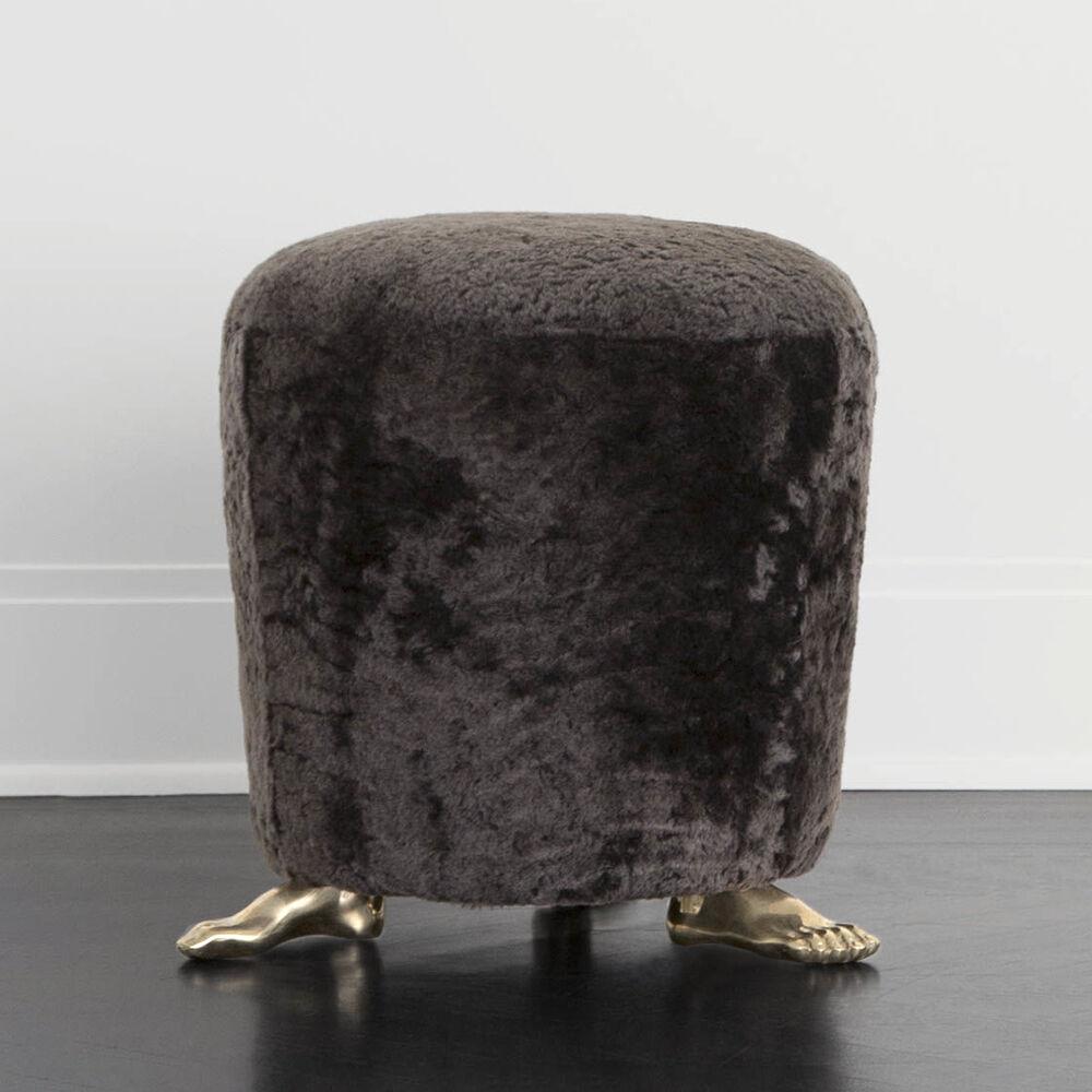 The foot stool is handmade from a seat of luxurious shearling mounted atop solid brass cast feet. Unexpected and eye-catching, it is perfect as an ottoman or petite seating at a vanity or console.

Measures: 6