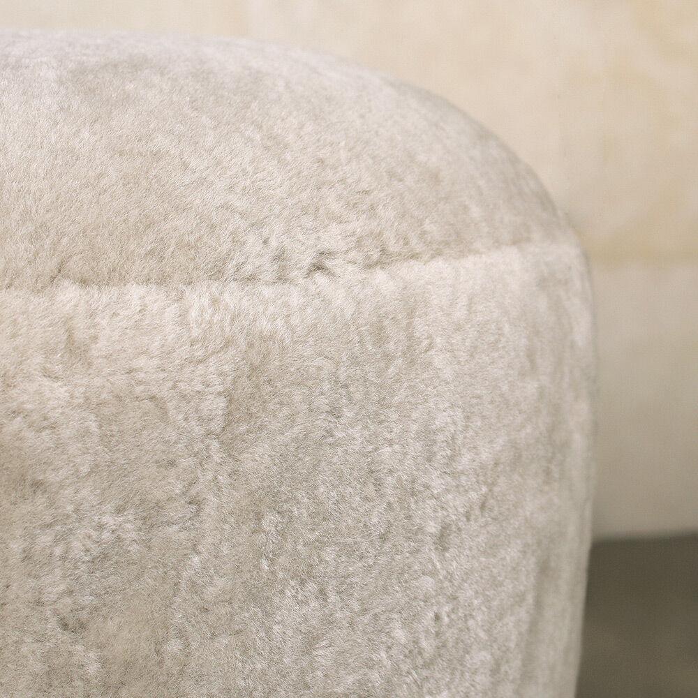 The foot stool is handmade from a seat of luxurious shearling mounted atop solid brass cast feet. Unexpected and eye-catching, it is perfect as an ottoman or petite seating at a vanity or console.

Measures: 6