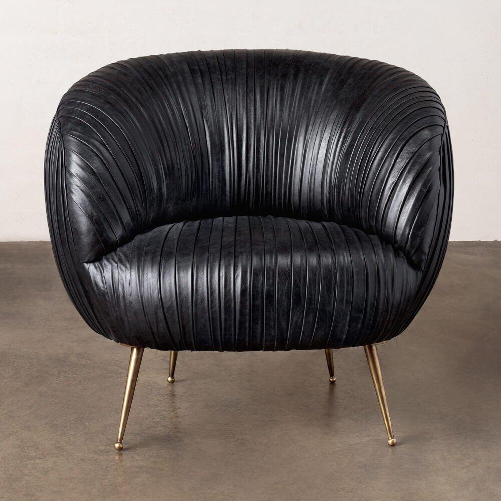 The delicate lines of this chair are created by a signature ruched leather detail. The hardwood frame is double-doweled and glued, with eight-way hand-tied springs. Full-finish, vegetable dyed lambskin is hand-stitched on to the frame. This