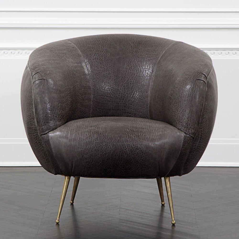 With its curvilinear form, bold massing, and thoughtful detailing, the Souffle Chair is a modern icon. This chair features solid cast burnished brass legs and a tightly upholstered body which is available in a curated selection of fabrics and