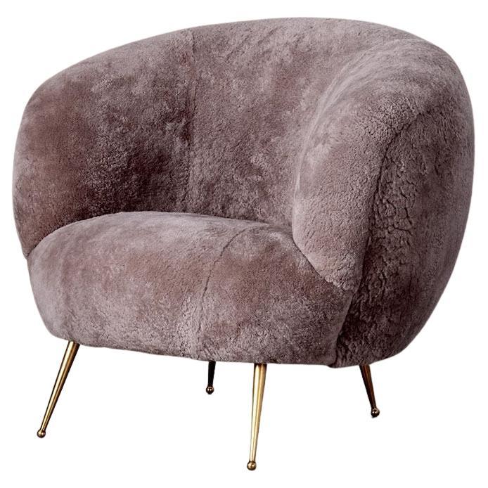 With its curvilinear form, bold massing, and thoughtful detailing, the Souffle Chair is a modern icon. This chair features solid cast burnished brass legs and an upholstered body which is available in a curated selection of fabrics and leathers.