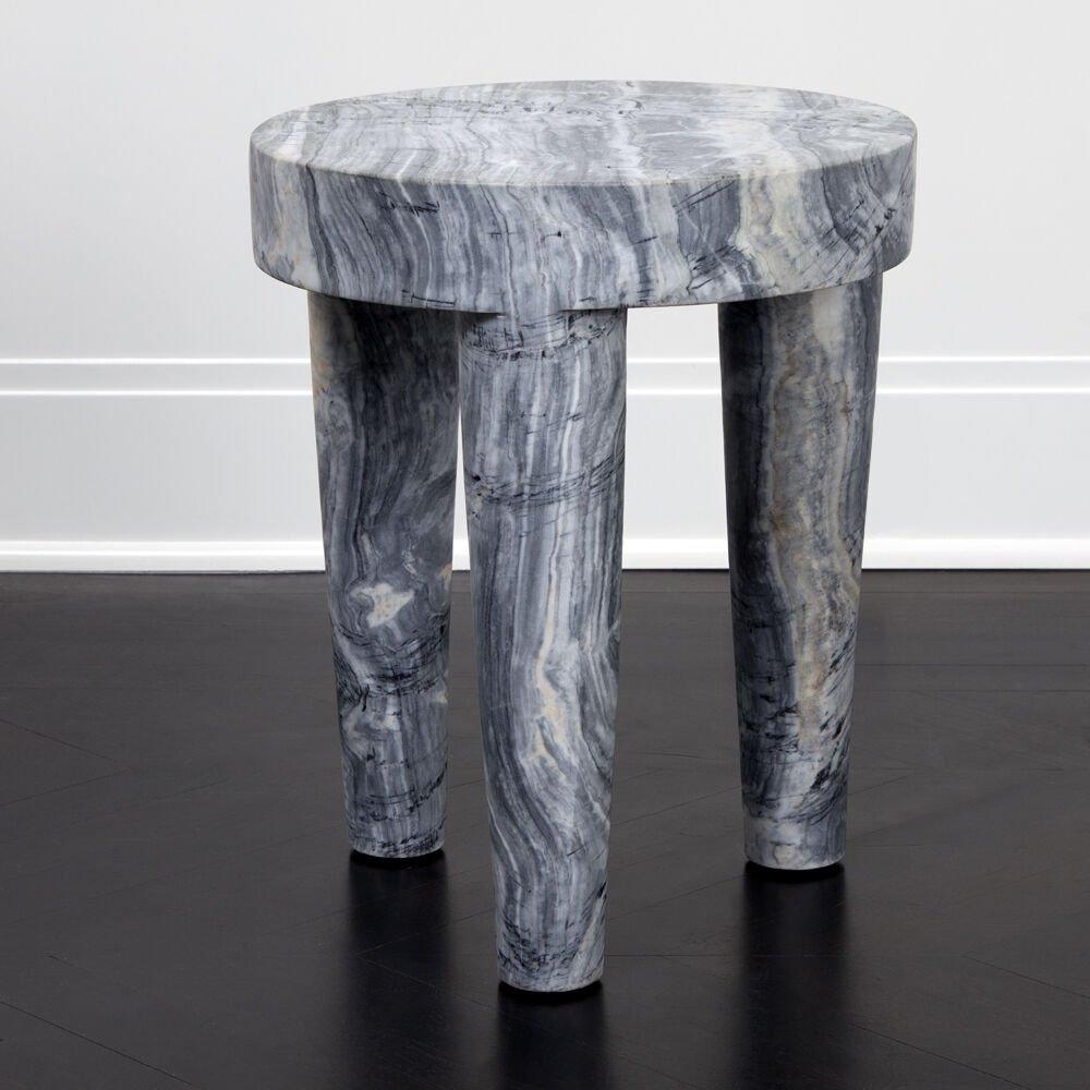 Hand-sculpted out of a solid block of marble, this stool or ottoman is a perfect example of a classic, modern shape that is effortlessly stylish. The Large Tribute Stool is perfect for outdoor or indoor seating, as a cocktail or side table, or as a
