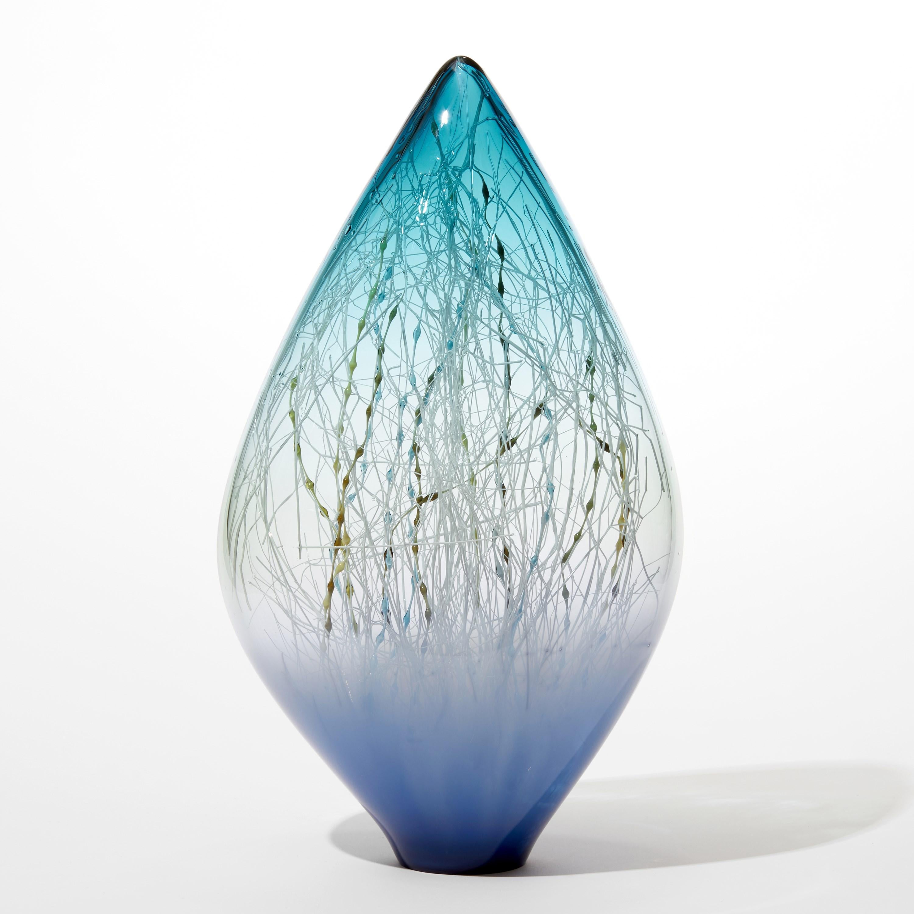 'Kelp in Azure & Aquamarine' is a unique handblown and sculpted glass artwork by the Danish and British artists, Hanne Enemark & Louis Thompson.

The outer glass form contains a multitude of fine canes of glass. Before the piece is finished, these