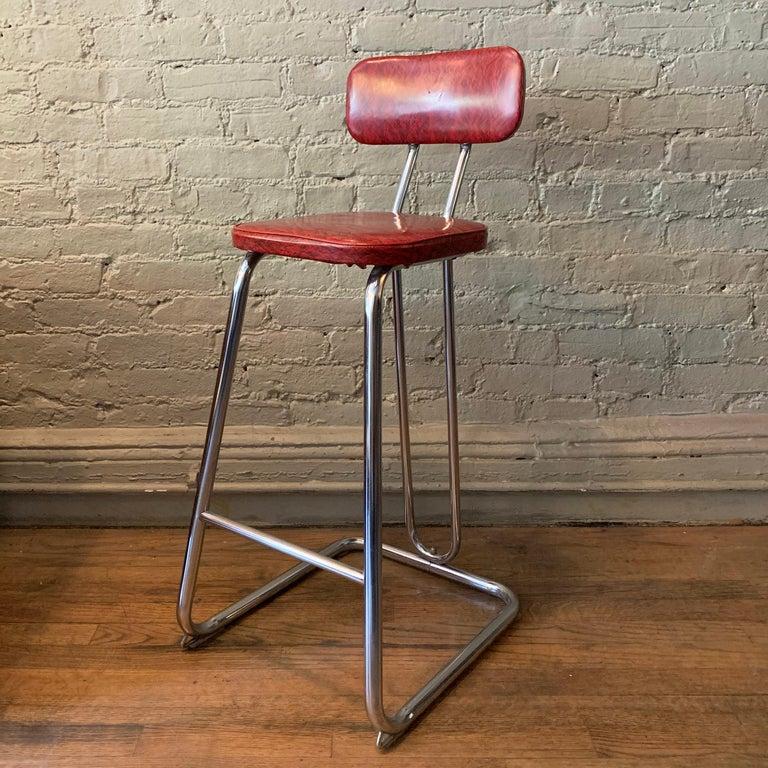 Art deco, counter height stool by KEM Weber features a chrome frame with marbleized vinyl seat and back.