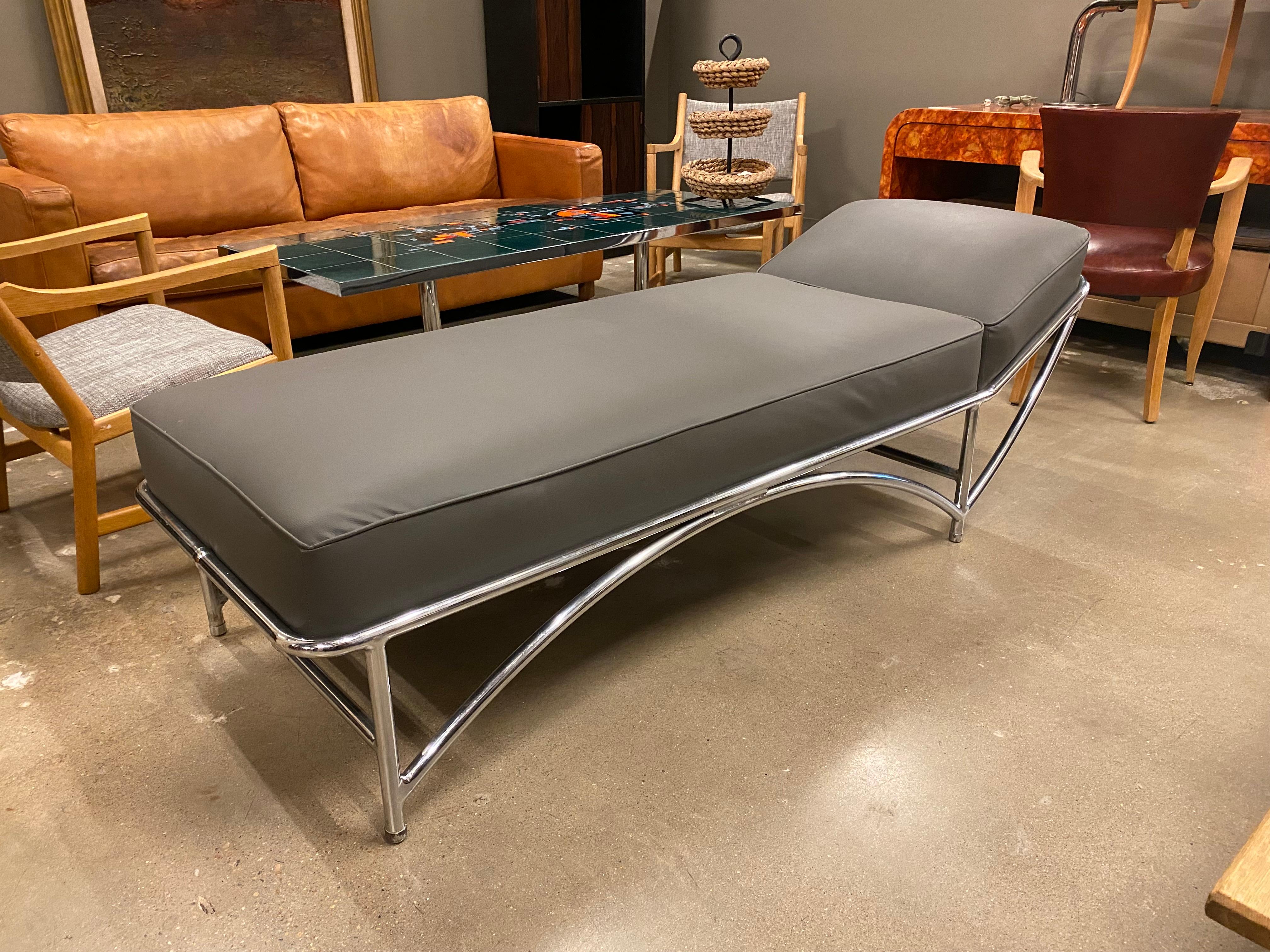 Art Deco/Machine Age daybed or chaise lounge by KEM Weber. Tubular steel in chrome finish with recently upholstered top in gray vinyl. c. 1930's Germany/United States.