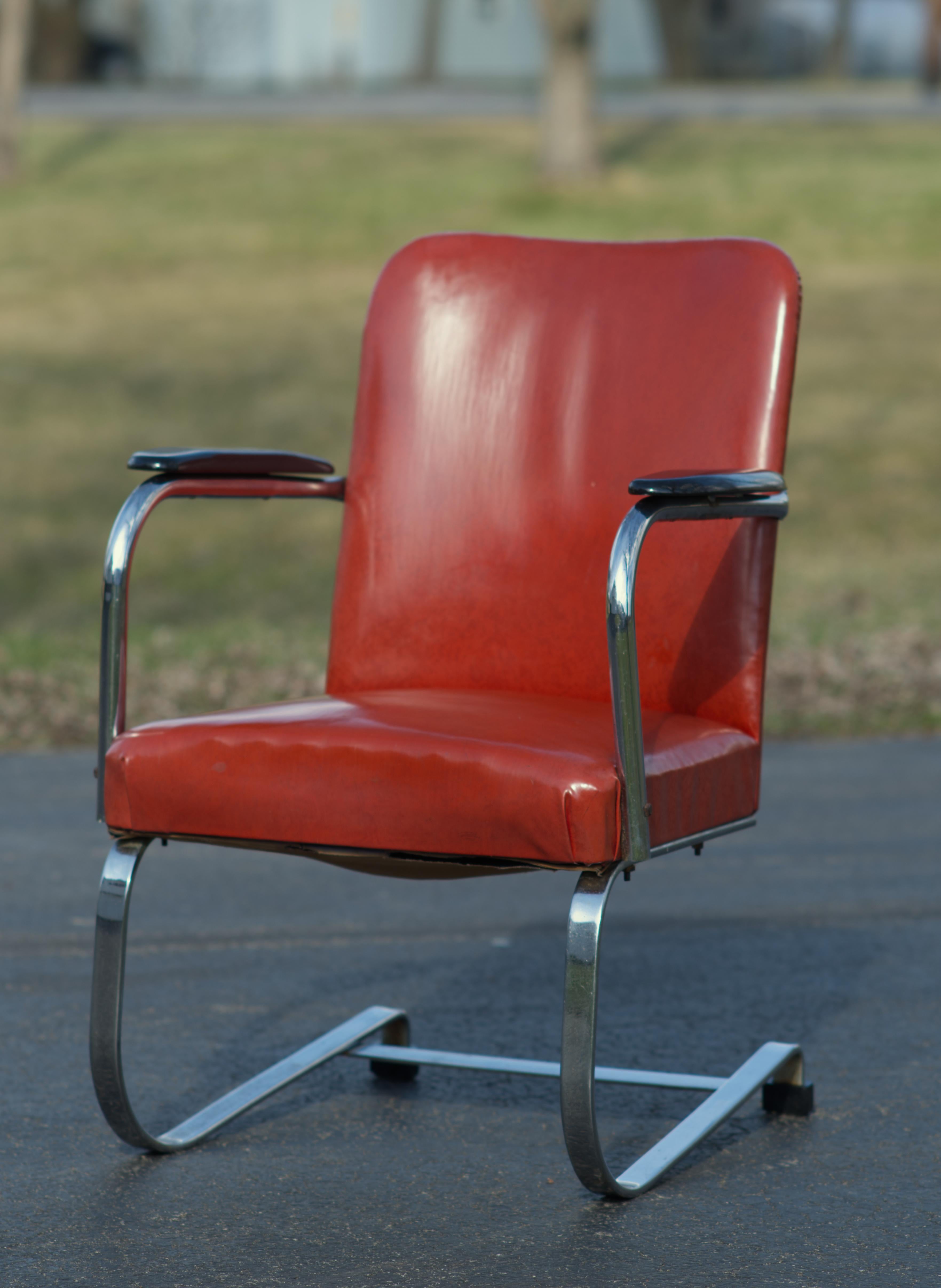 Lovely example of (Karl Emmanuel Martin)  Kem Weber Cantilever Lounge Chair manufactured by Lloyd. 
Vinyl is in a surprisingly good condition with few minor pinhead size spots. It is red/coral color. No tears or cracks. 
Chrome plating is worn out