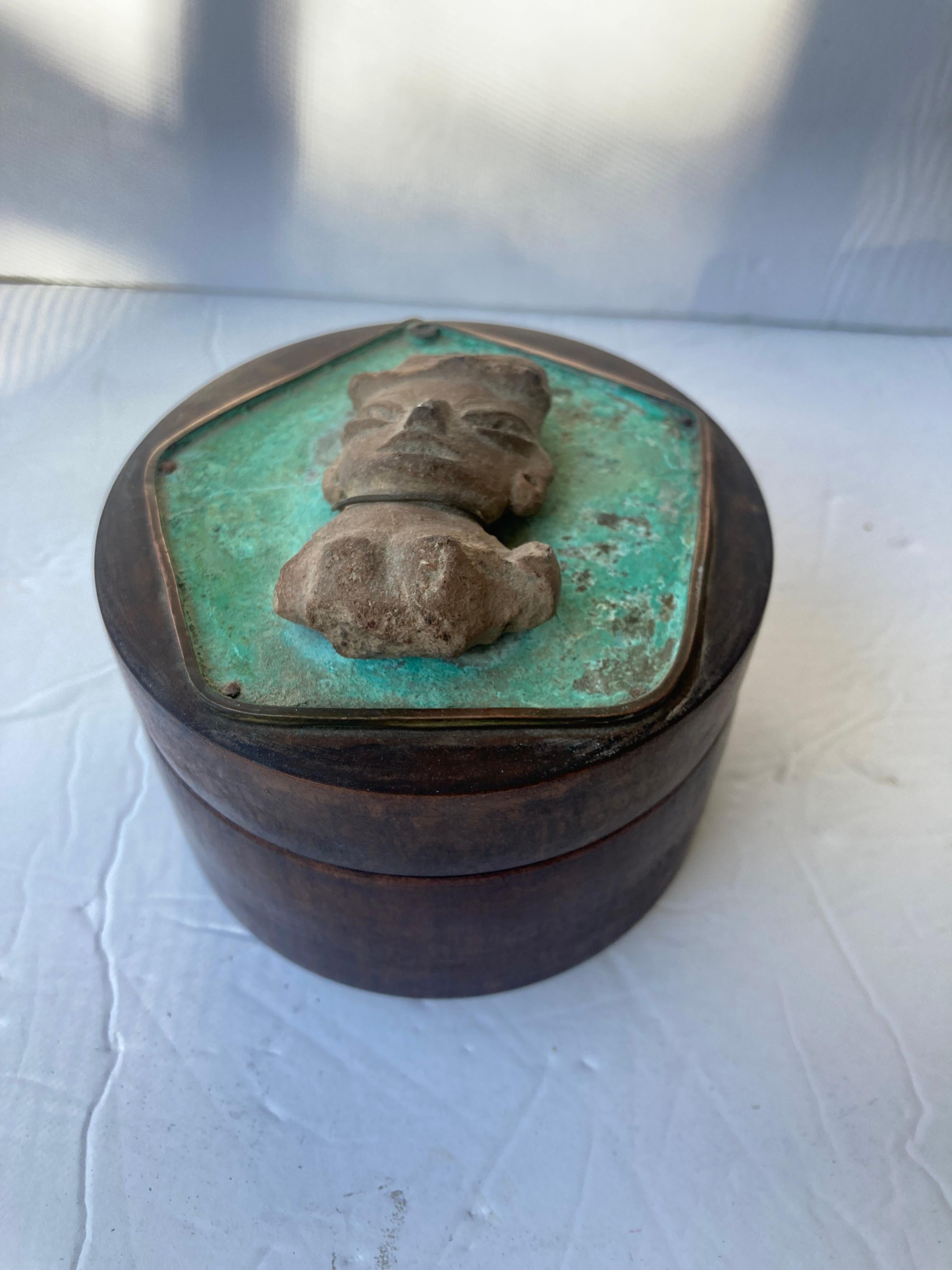 Beautiful jewelry box by the known American artist Ken Belgian. He worked in Taxco, Mexico in a modern/primitive style craft . This wooden box has copper and a figure that appears to be pre-columbian style head, and is signed inside lead in pencil.