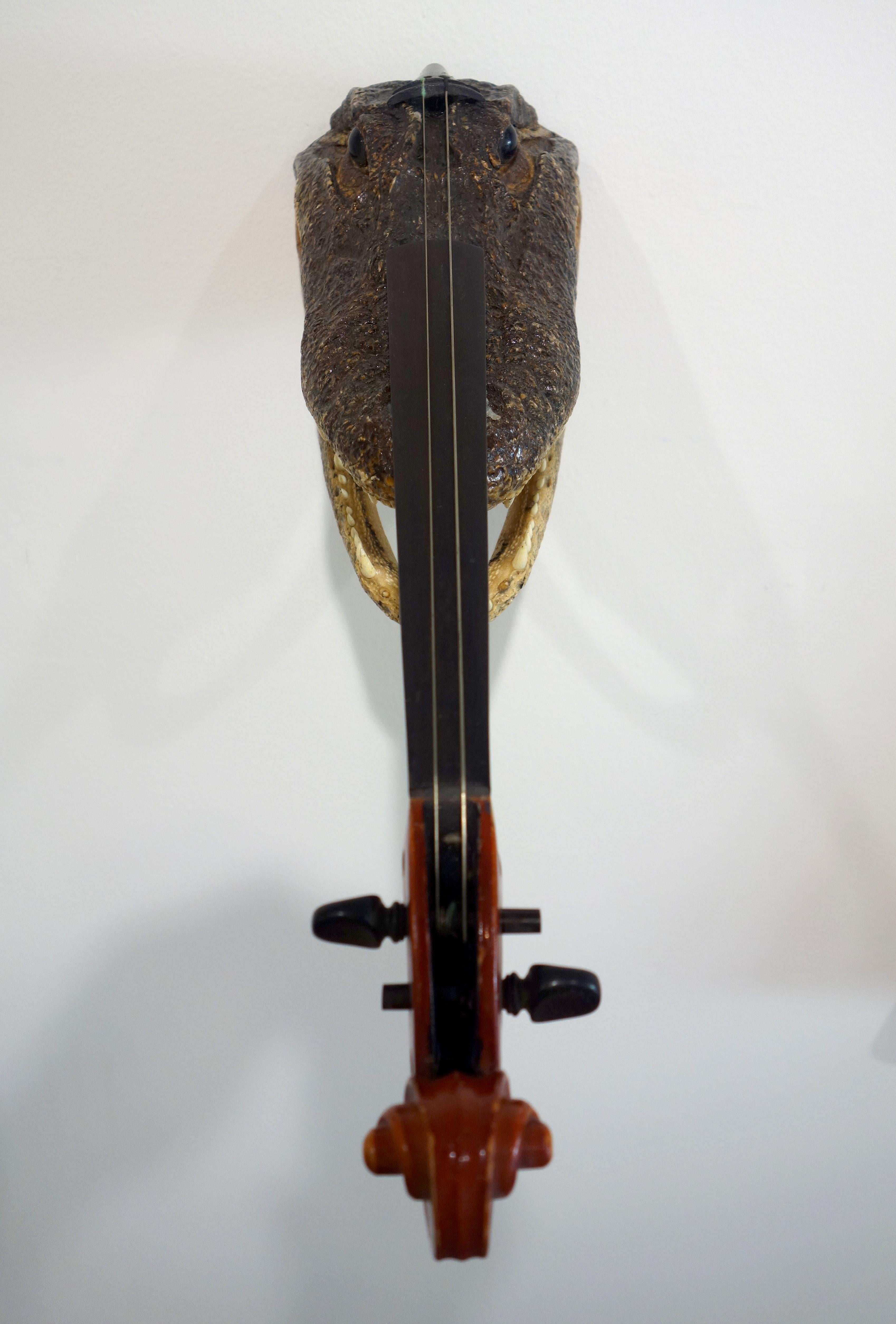 This violin sculpture created by Ken Butler is part violin part crocodile head. It is made in the spirit of absurdity many surrealists embraced using found objects in functional scenarios.

Ken Butler is renowned for his innovative approach to