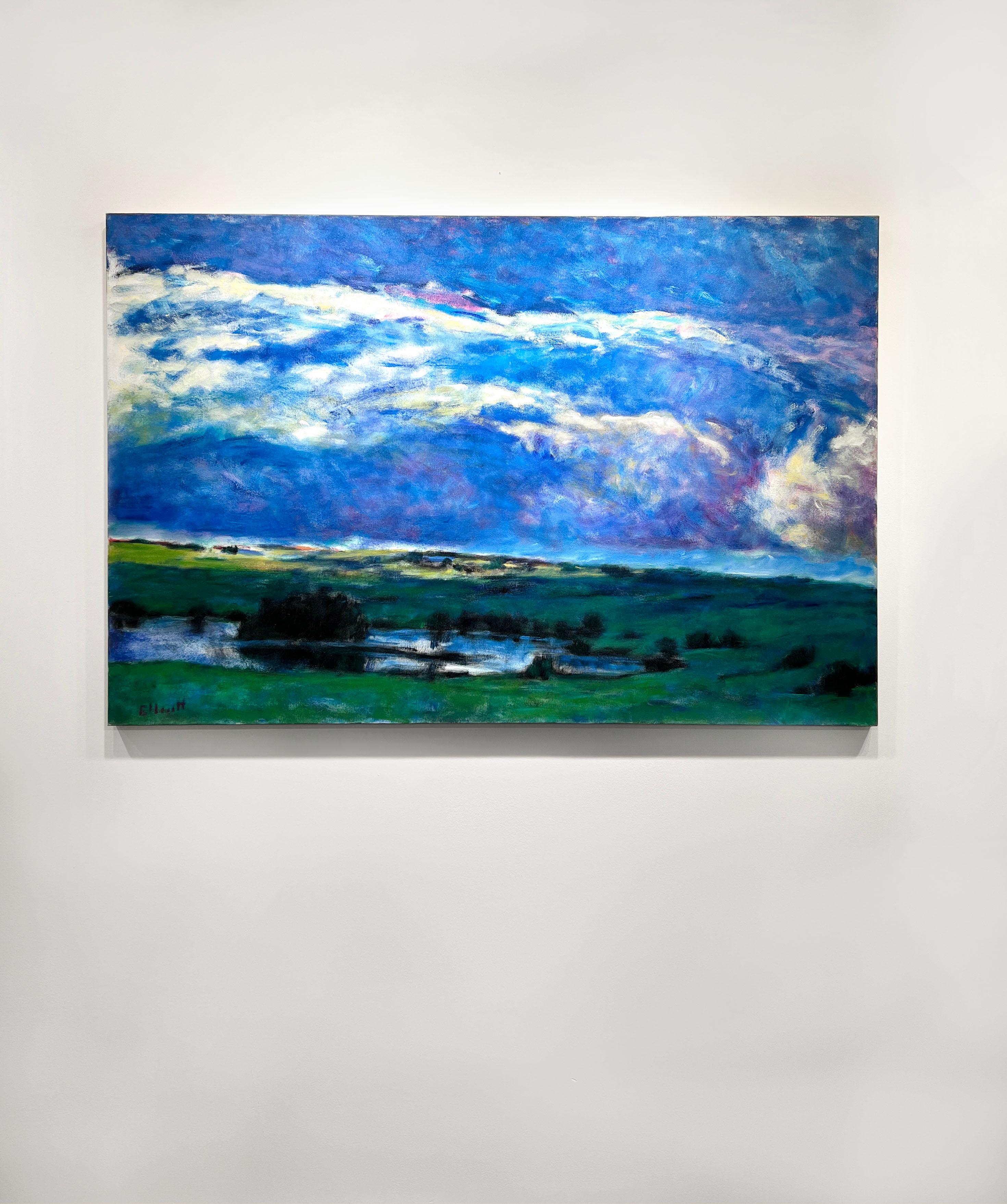 This abstract landscape painting by Ken Elliott features a cool palette. An expressive blue and lavender sky with white and yellow accents is pictured above saturated green land with dark trees and shrubs, and a light blue pond. The painting is