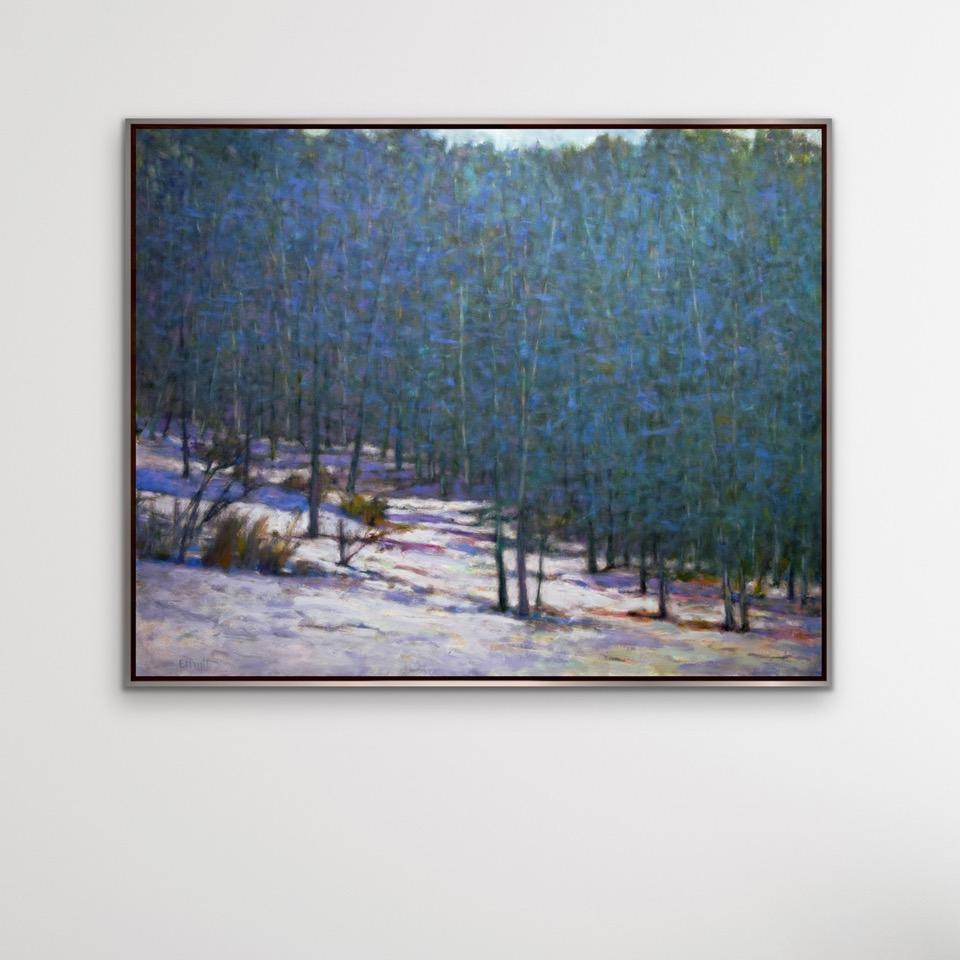 'Found Colors at the Snows Edge II' 2023 by American artist, Ken Elliott. Oil on canvas, 48 x 60 in. / Frame: 49.75 x 61.75 in.This painting of a forest and snowy ground comprises of colors in blue, green, brown and white. Framed in a gold painted