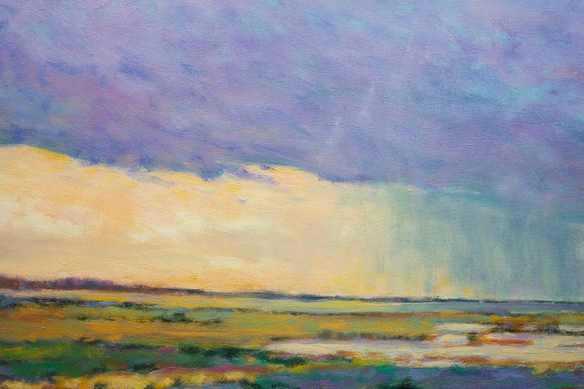 This abstract landscape painting by Ken Elliott is made with oil paint on canvas. It captures, in an almost impressionistic style, a multicolored field with yellow, purple, green, and pink layers beneath a purple, blue, and yellow sky. The painting