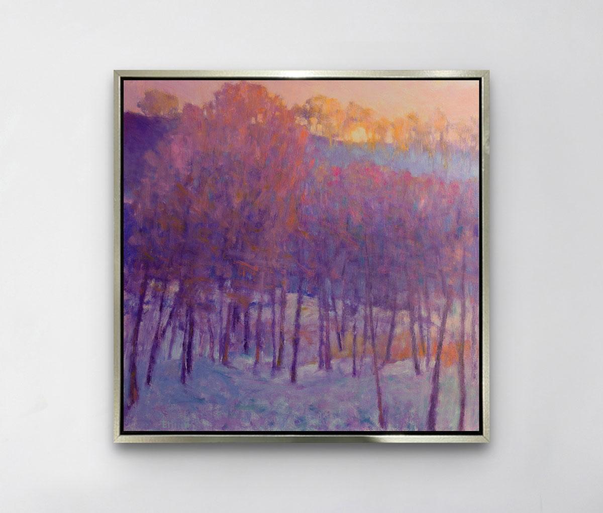 This abstract landscape by Ken Elliott is a limited edition print. It depicts a forest of trees sitting in a blanket of snow, and a subtle sunset above the top of the forest. The thin trees' trunks are a deep violet, which are contrasted the muted