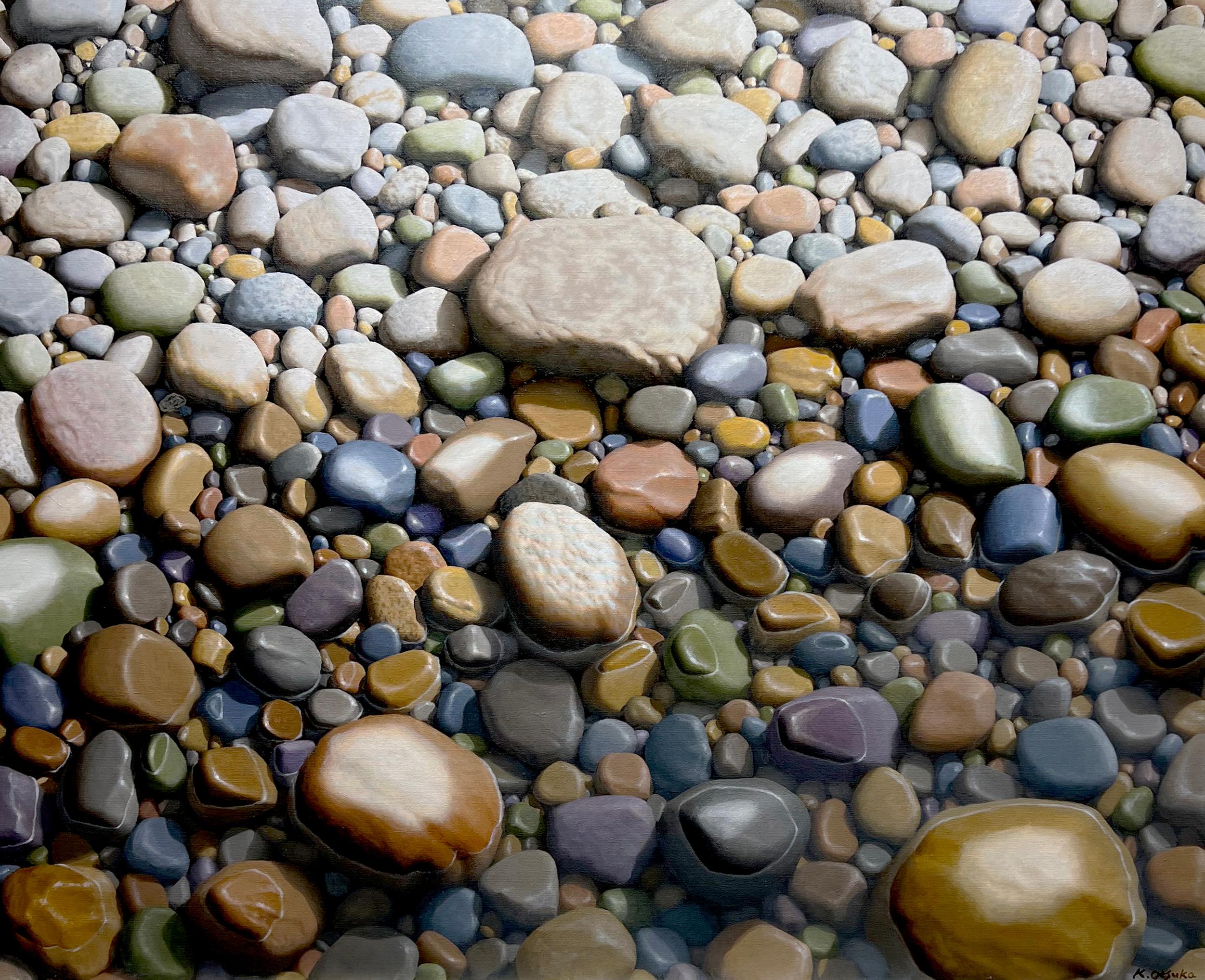 This serene piece, "Quiet Conversation", is a 38x46 oil painting on canvas by artist Ken Otsuka featuring a unique perspective, looking straight down on a pebble covered beach.  Hundreds of multi-colored rocks and pebbles scatter the ground, half