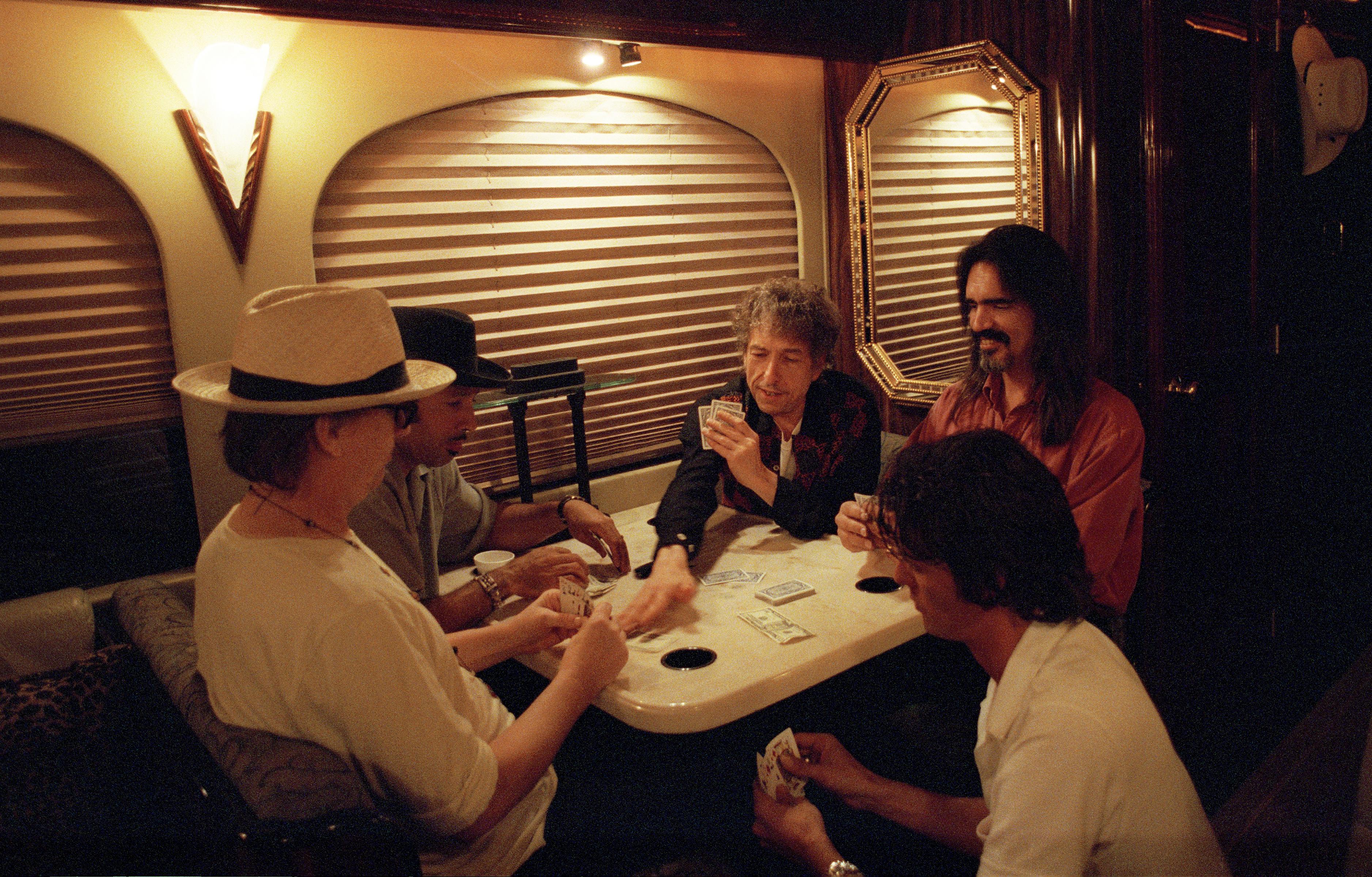 Ken Regan Color Photograph - Bob Dylan and the band playing poker on the bus, 2001