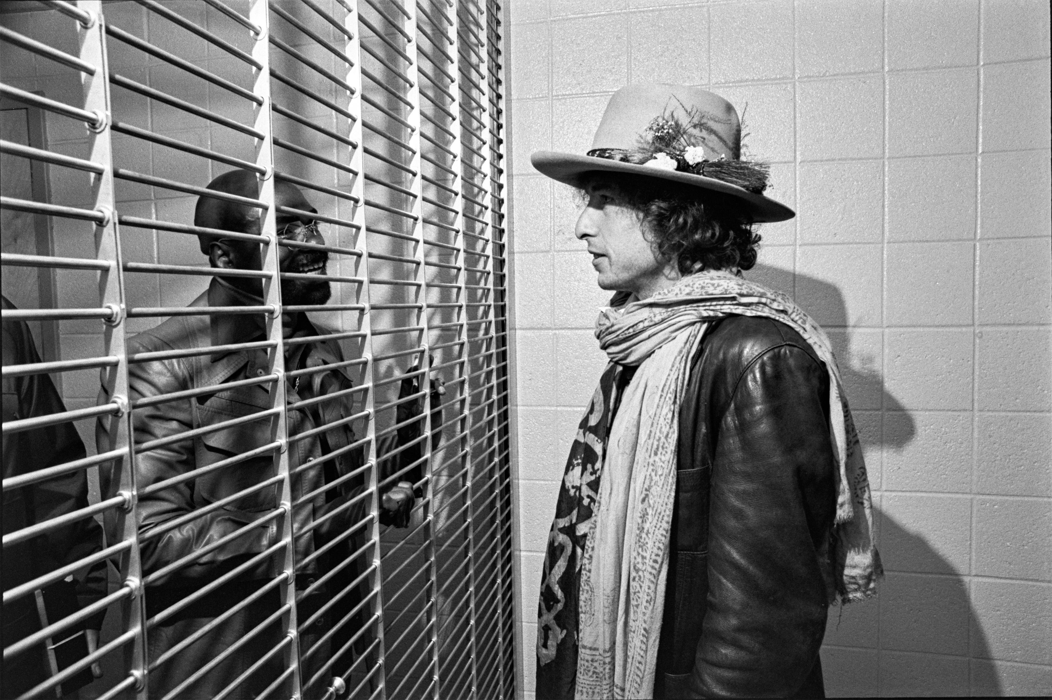Ken Regan Black and White Photograph - Bob Dylan at Prison Cell of Rubin Hurricane Carter, Trenton State Prison