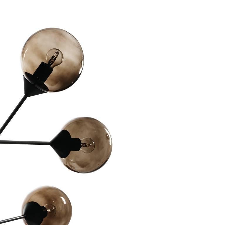 Chandelier by Massimo Zazzeron e Centro Ricerche with burnished bronze structure and smoked bronze glass sphere diffusers, available from showroom display. 
Measures: 55