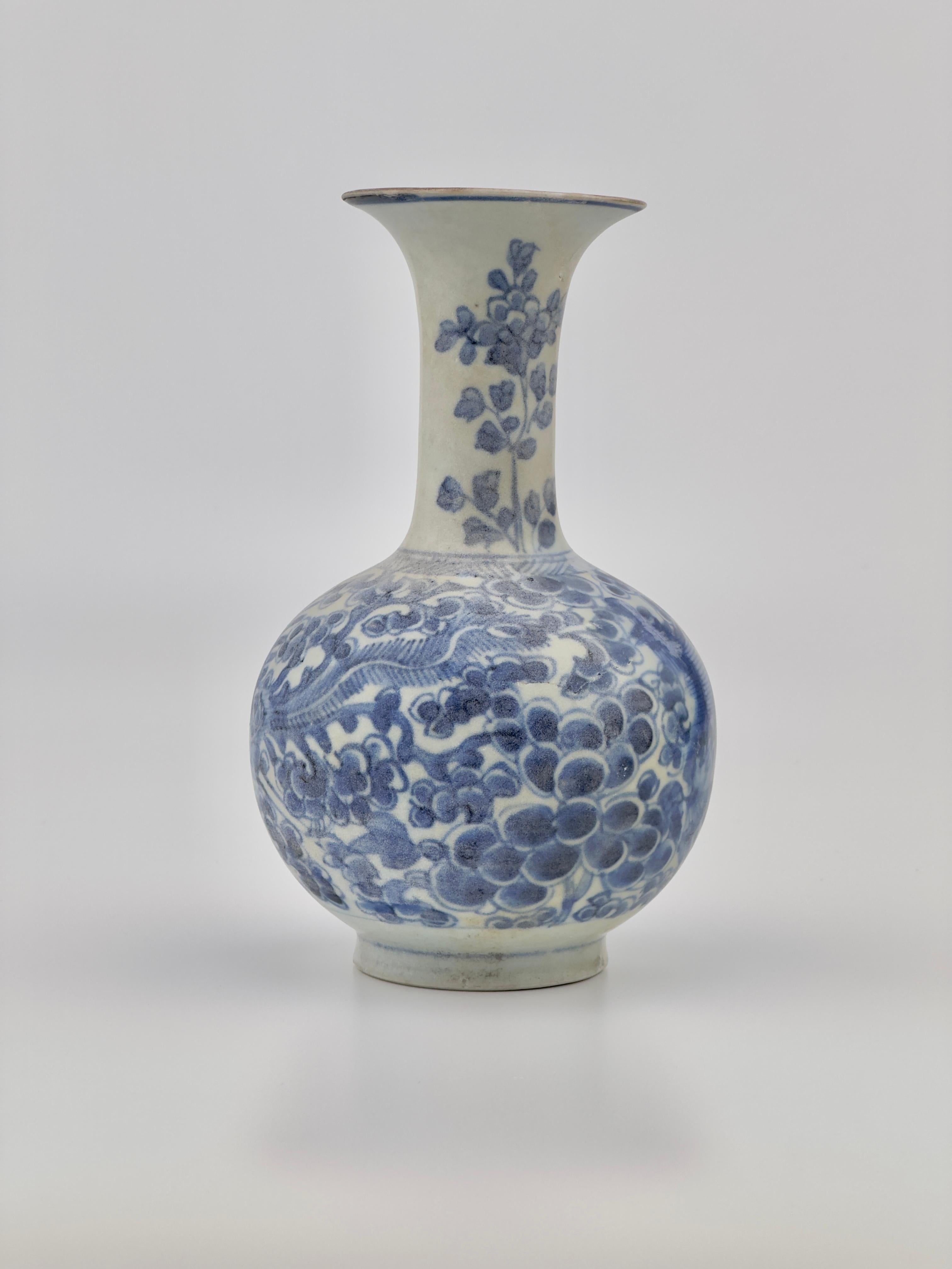 The Kendi is decorated with cobalt blue underglaze depicting flowers and a mythical bird, reflecting the artistic finesse and symbolic expressions of the era. These designs often carry symbolic meanings, with birds sometimes representing immortality