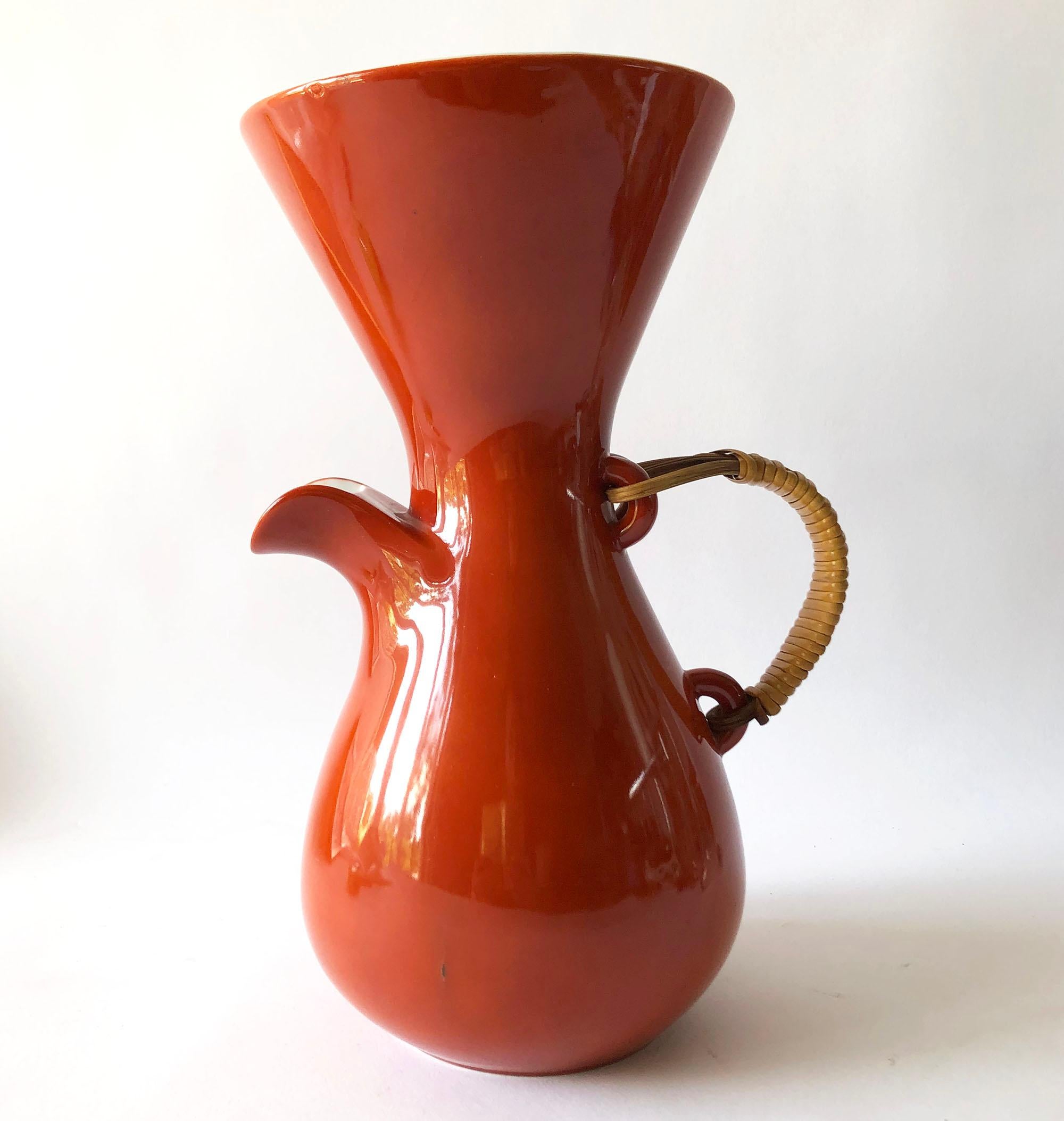 Ceramic coffee pot or pitcher with raffia handle designed by Kenji Fujita for Freeman Lederman. Pitcher measures 11.5