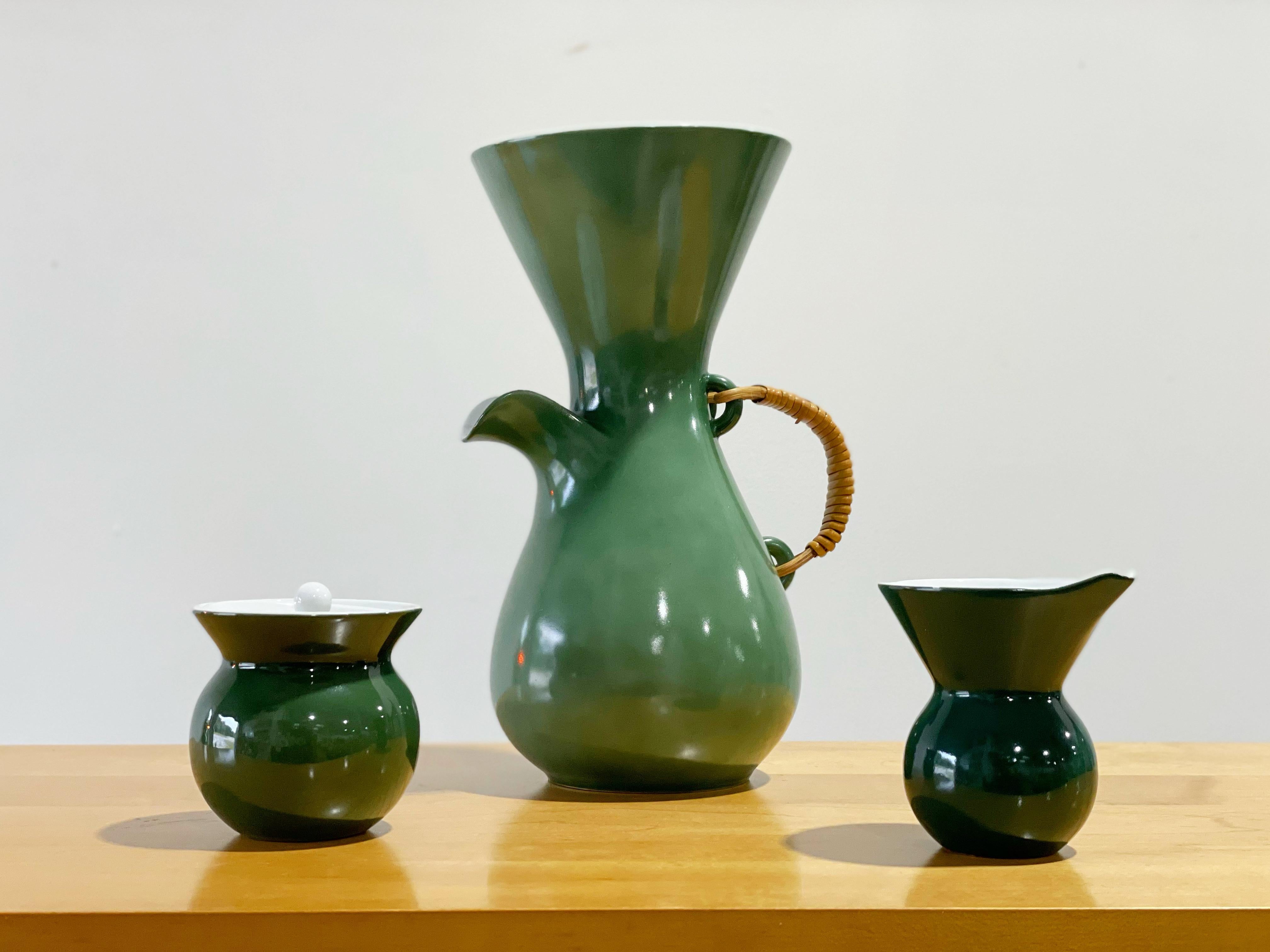 Exquisite modern coffee set designed by Kenji Fujita for Freeman Lederman. Coffee carafe, lidded sugar dish and creamer in rare green glaze with glossy white interior. Each piece is marked with the FL logo. The set is unique on the market currently.