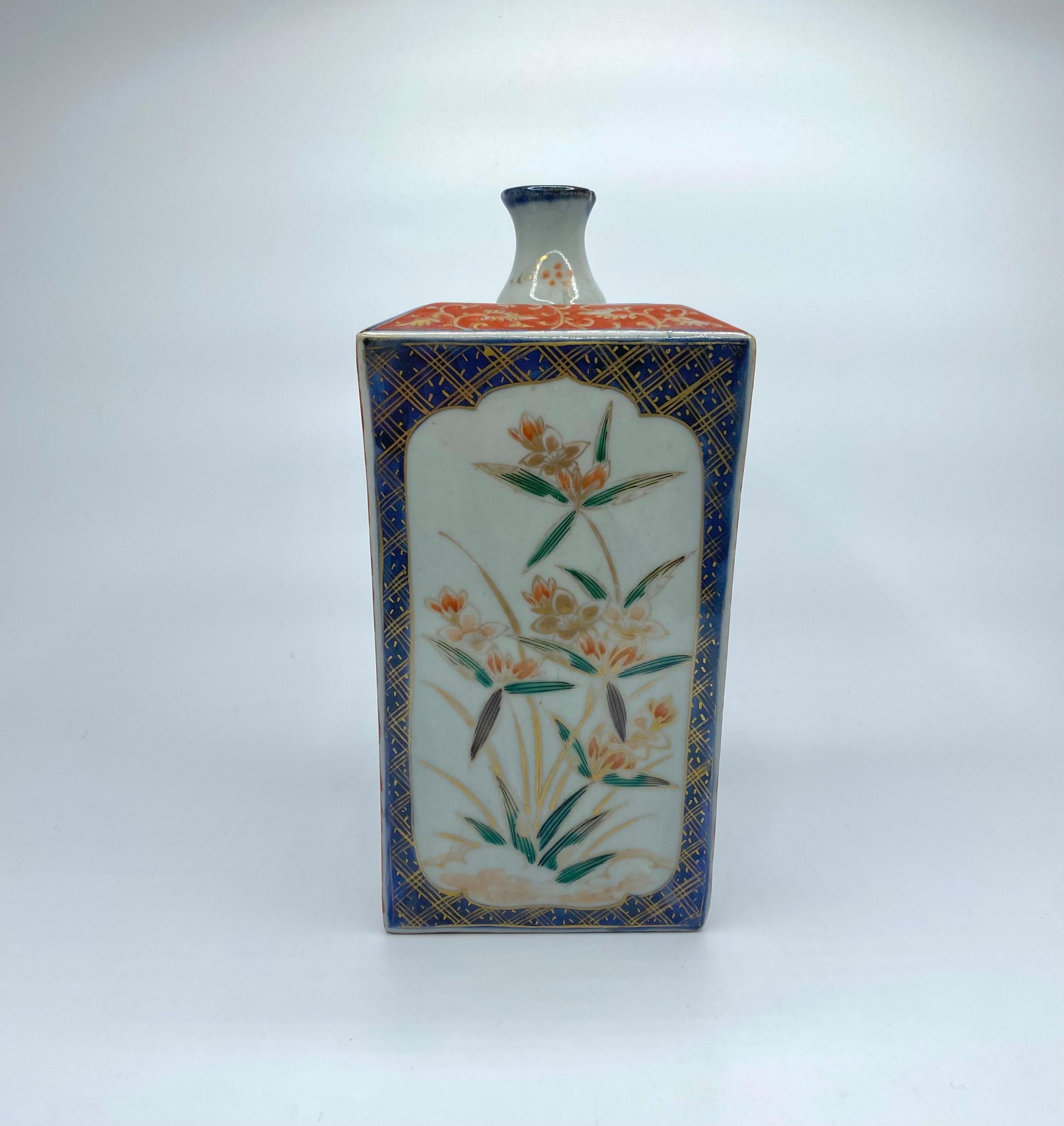 Japanese Imari porcelain tokuri, Arita, circa 1700, Genroku Period. The squared vessel painted with shaped panels of flowering plants, upon textile design inspired grounds. Rising to a similarly decorated raised shoulder, surmounted by a shaped