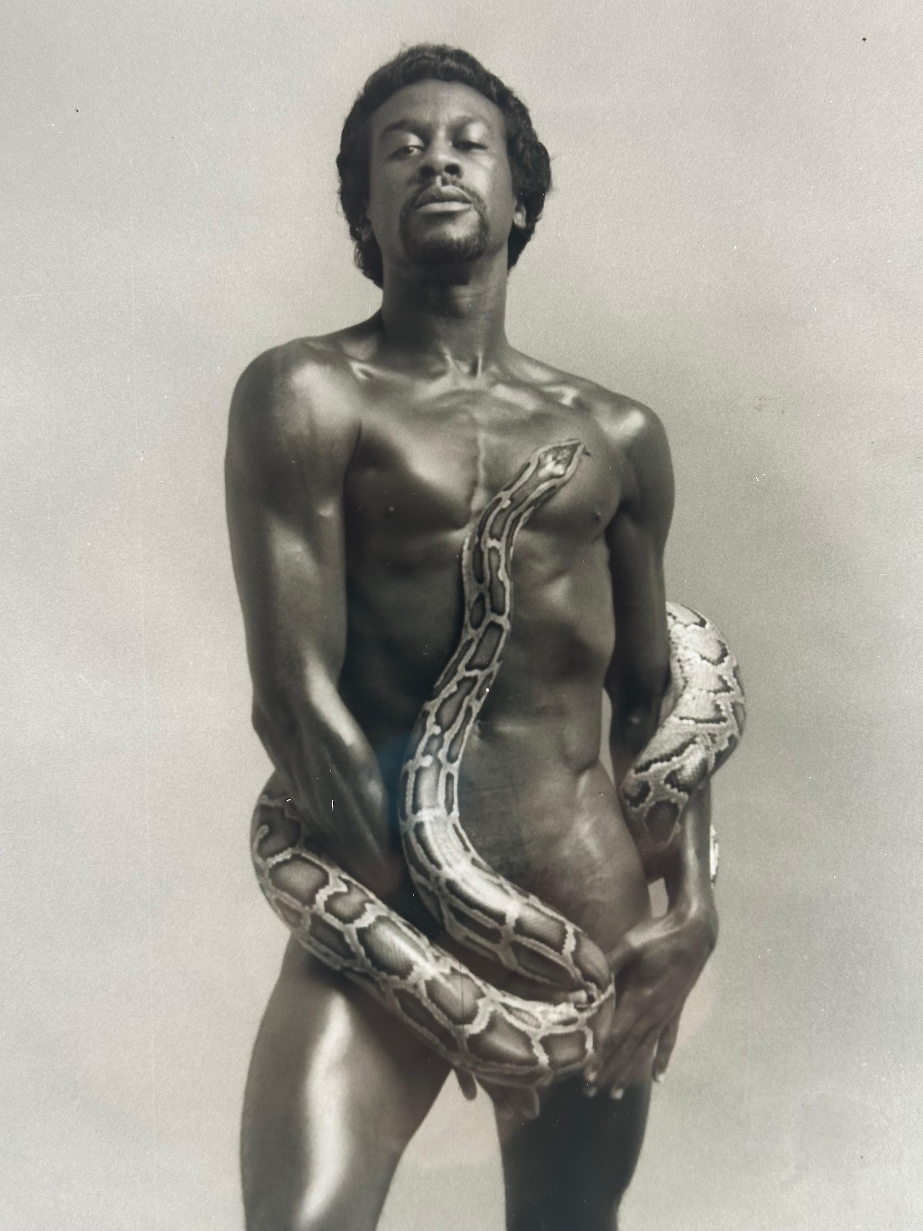 Portrait of Tommy Hawkins with Python - American Realist Photograph by Kenn Duncan