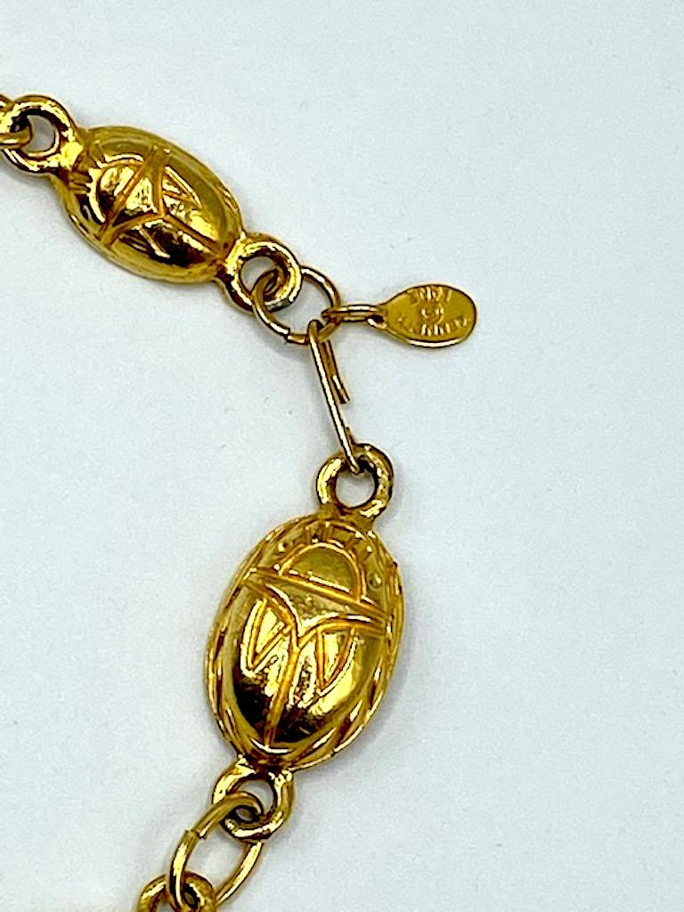 Dating from the late half of the 1970s to the mid 1980s is this unusual and rare Kenneth Jay Lane scarab link long necklace. Due to the popularity of the contents and artifacts of the King Tutankhamon exhibition that toured the world from 1972 to