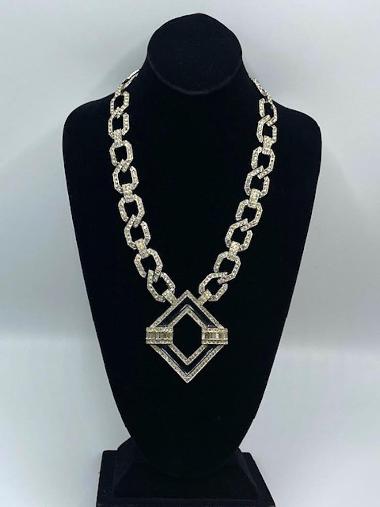 A lovely and impressive example of the artistry of American fashion jewelry designer Kenneth Jay Lane. The necklace was produced in the mid 1980s and is an Art Deco inspired design. The piece is rhodium plated and set with rhinestones. Additionally,