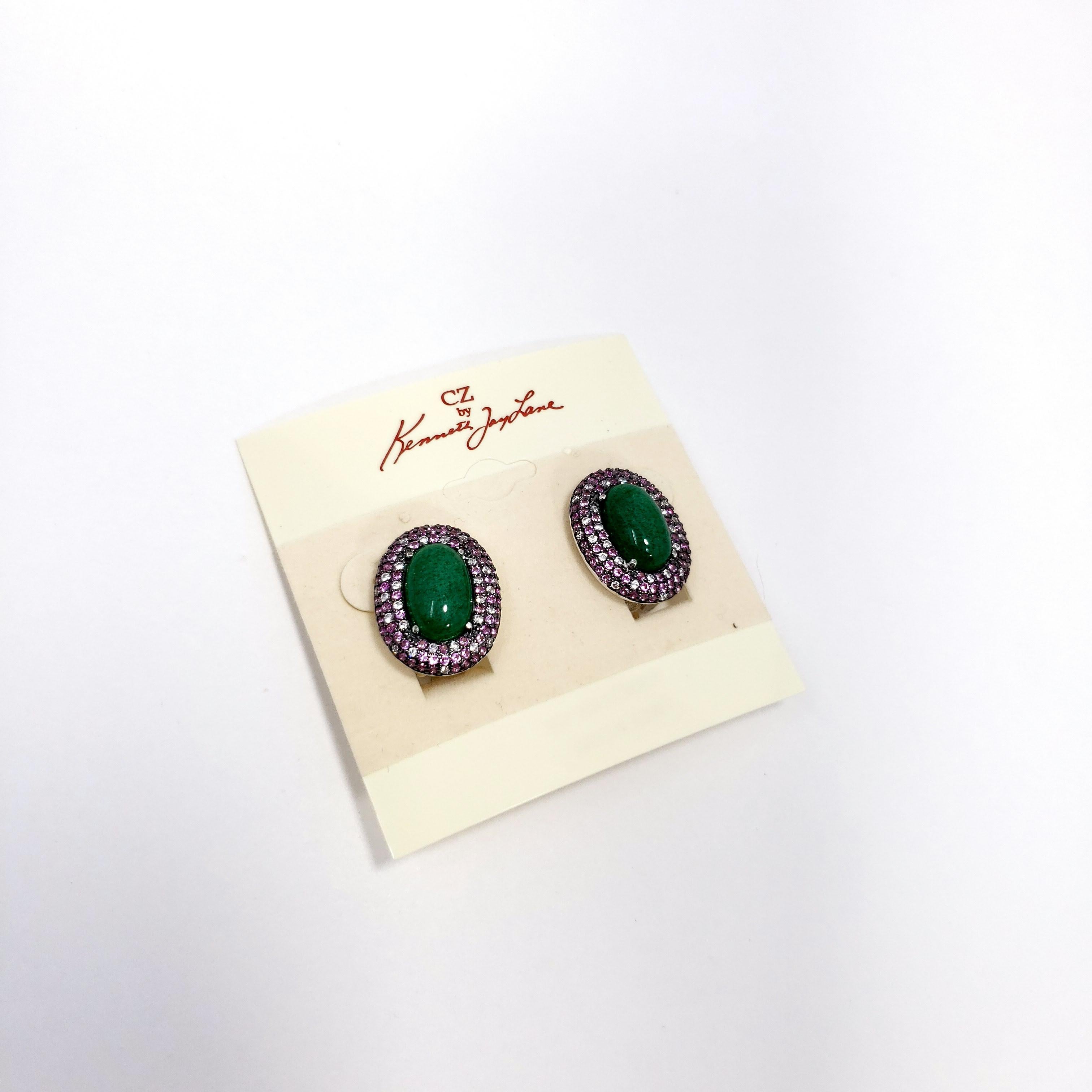 Stylish clip-on earrings by Kenneth Jay Lane! Each silvertone earring  features a single green cabochon, accented with rose and clear cubic zirconia crystals.

Hallmarks: KJL