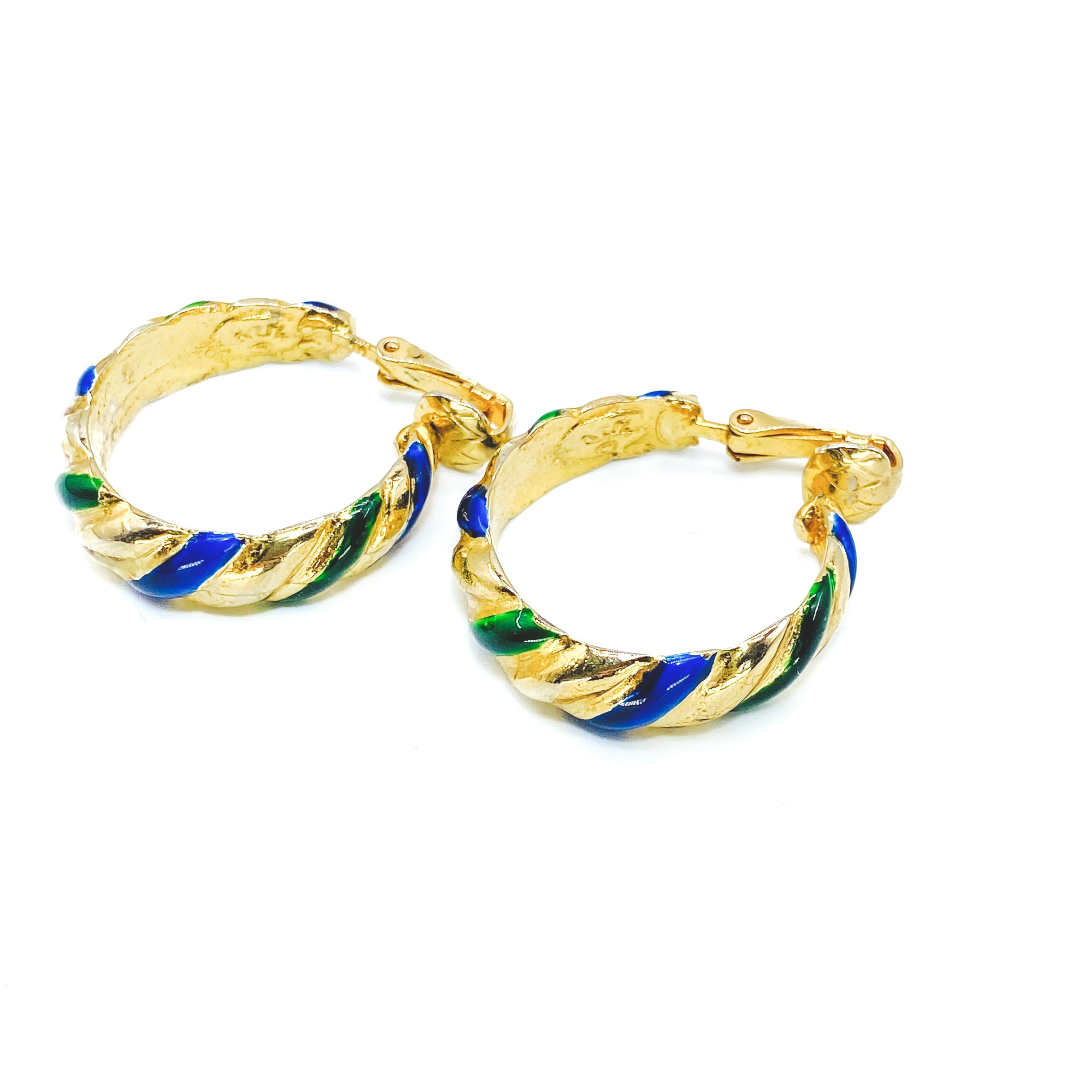 Kenneth Jay Lane 1980s Clip on Hoop Earrings

Detail
-Made in the USA in the 1980s
-Crafted from 1980s
-Inlaid with blue and green enamel

Size & Fit
-Approx 1 inch across 
-Strong clips

Authenticity & Condition
-Fully examined and authenticated by