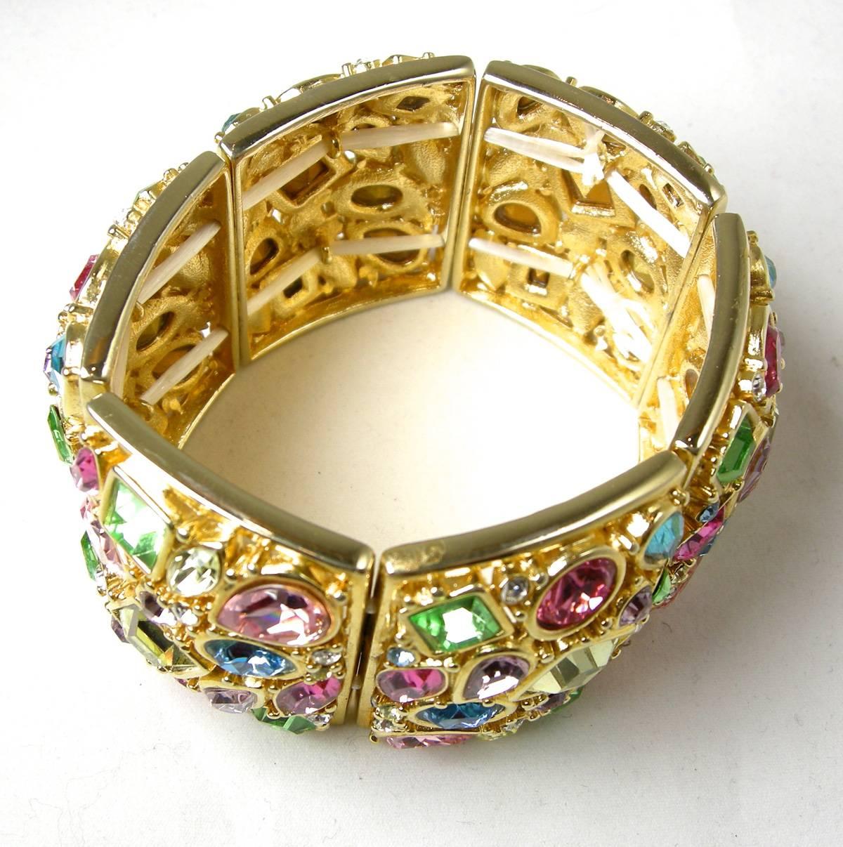 The beautiful multi-color stretch bracelet is embellished with different shapes crystals of pinks, blues, green and lavender all bezel into a gold tone metal finish. There are six rectangular segments … each measuring 1-3/4” long x 1-1/2” wide and