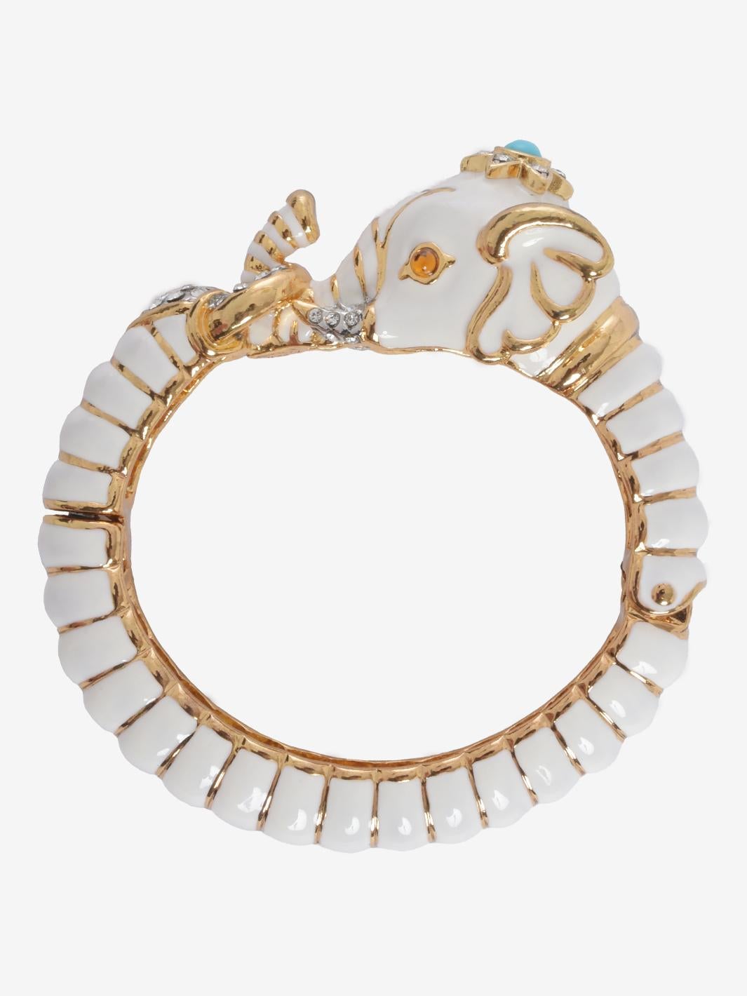 Kenneth Jay Lane Elephant Bracelet With Polychrome Rhinestones is a unique design made in the 1960s, a period when Lane, like the Beatles, traveled to India numerous times, inspiring him deeply. White enamel with polychrome rhinestones on American