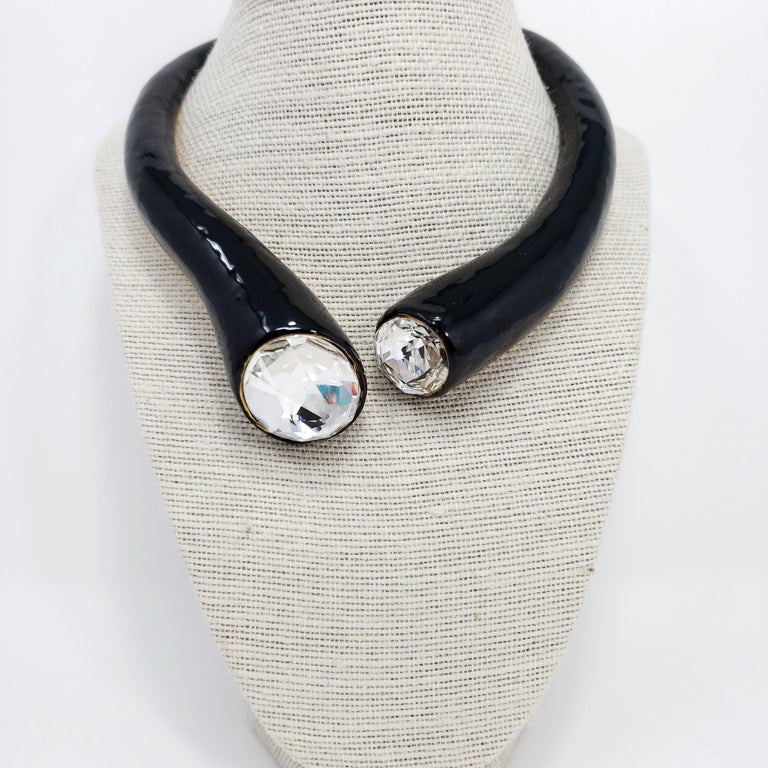 Elegant spring-hinge golden collar necklace painted in black enamel and accented with two large crystals. By Kenneth Jay Lane.

Old-new stock from earlier KJL collections. Wonderfully preserved. Never worn.

Hallmarks: Kenneth Lane, Made in