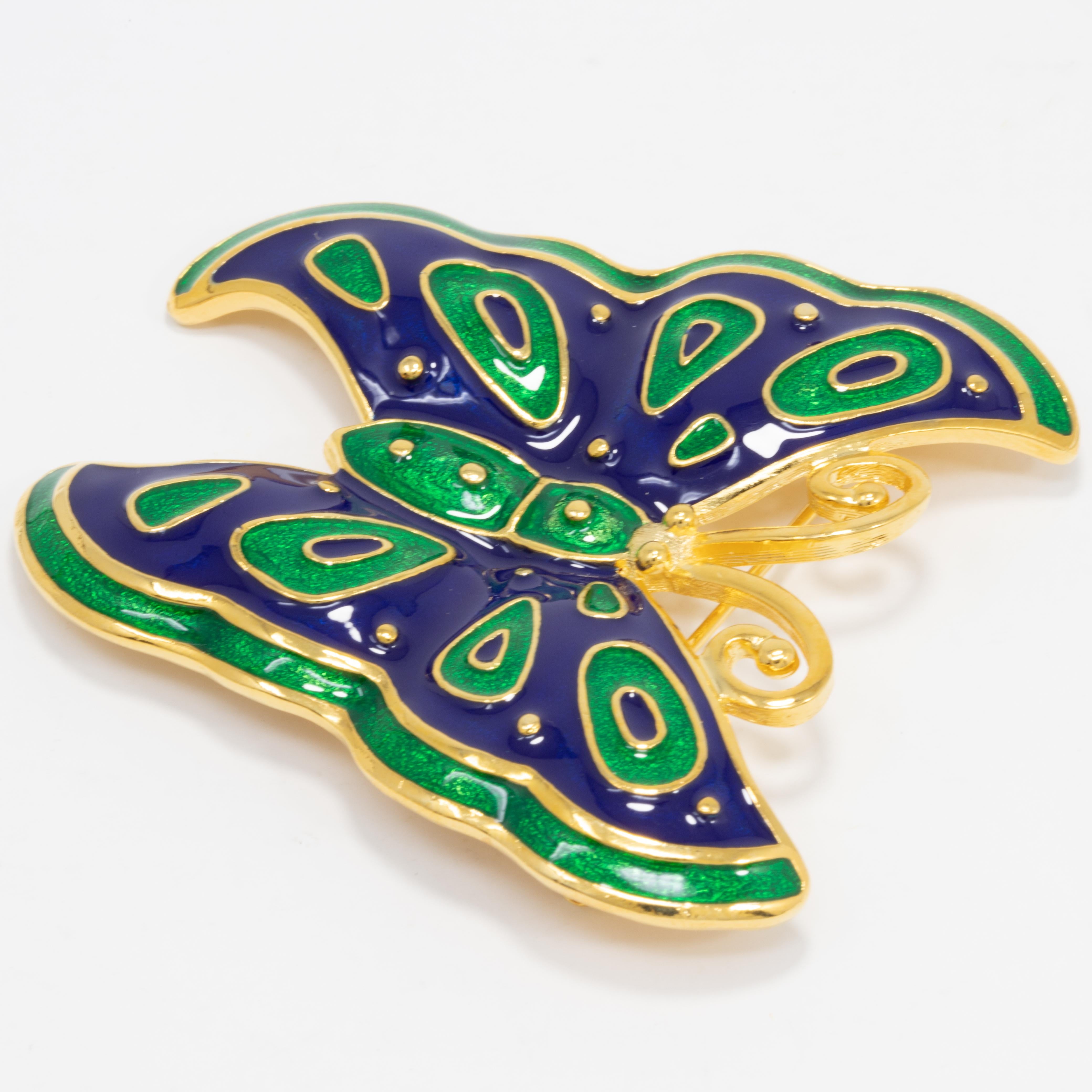 A stylish butterfly pin brooch from Kenneth Jay Lane. This golden critter is painted with emerald green and indigo blue enamel.

Marks / hallmarks / etc: Kenneth Lane, Made in USA