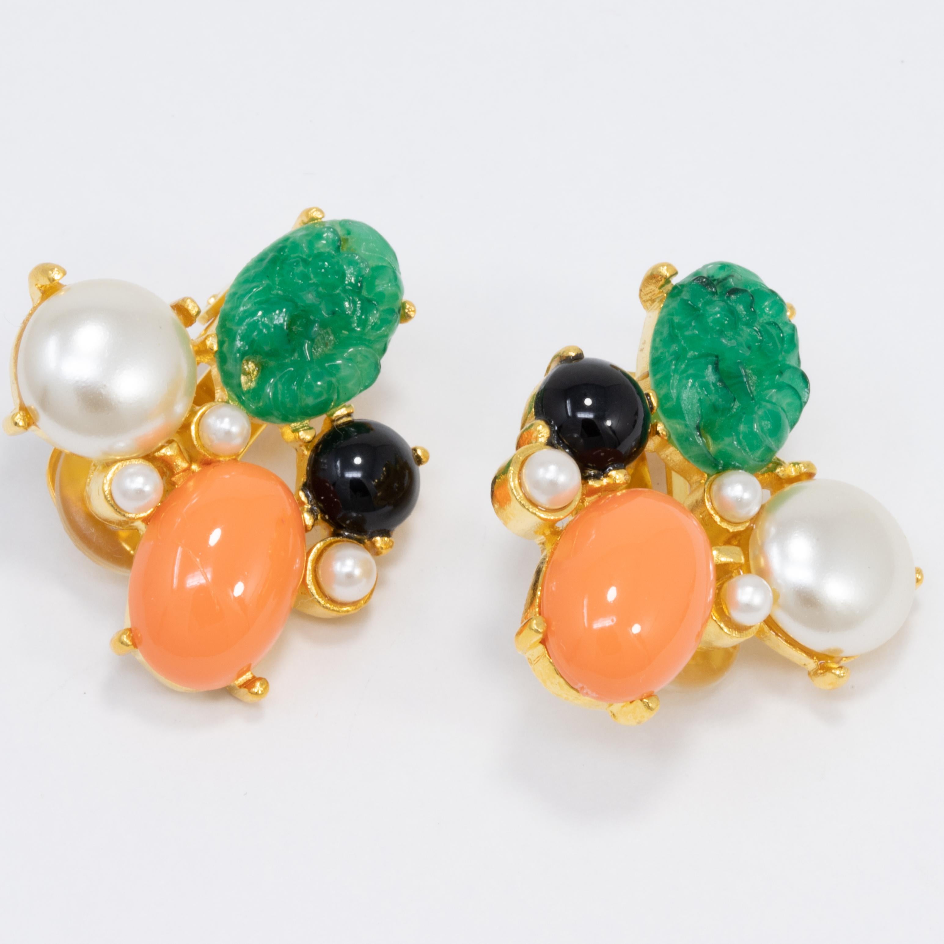 A pair of golden earrings by Kenneth Jay Lane, featuring prong-set faux pearls, carved jade, and cabochons.

Hallmarks: KJL, Made in USA

Gold plated.