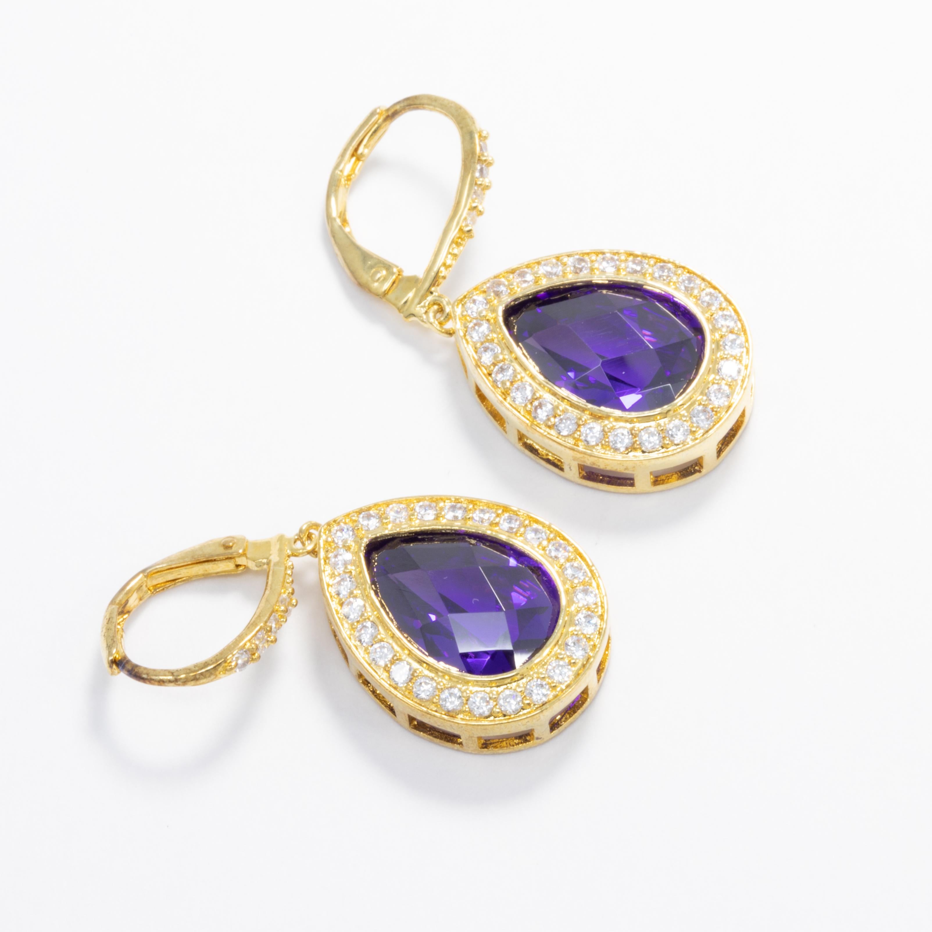 Add some sparkle to your outfit with these gold plated pear dangle earrings by Kenneth Jay Lane.

Clear and purple amethyst cubic zirconia crystals. Lever hook closure.

Marks/Hallmarks: KJLane

CZ by Kenneth Jay Lane line. Designed in New York.