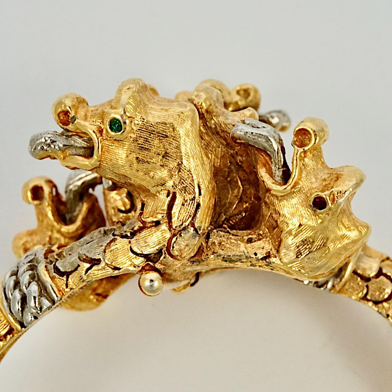 Fabulous early Kenneth Jay Lane gold plated and silver plated bangle bracelet, with a wonderful textured dragon design featuring six dragon heads. Inside measurements, width 6.1 cm / 2.4 inches by length 5 cm / 1.9 inches. The bracelet has signs of