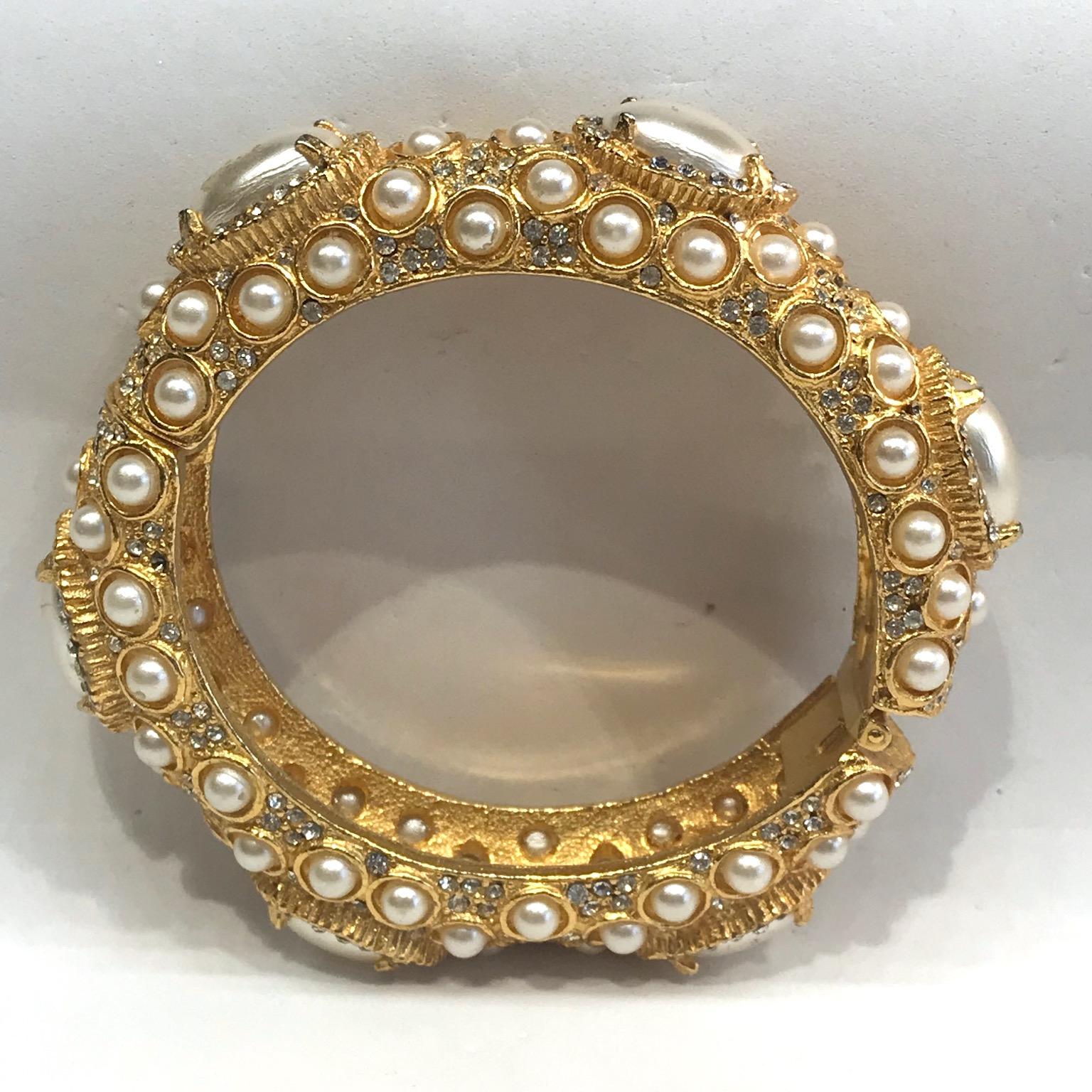 A very nice Kenneth Jay Lane 1980s clamper style hinge bangle from the Grace Collection. Originally produced in the 1960s, the Grace Collection is an iconic design of Kennth Lane. In the 1980s, Lane worked with the Laguna Jewelry Company, known for
