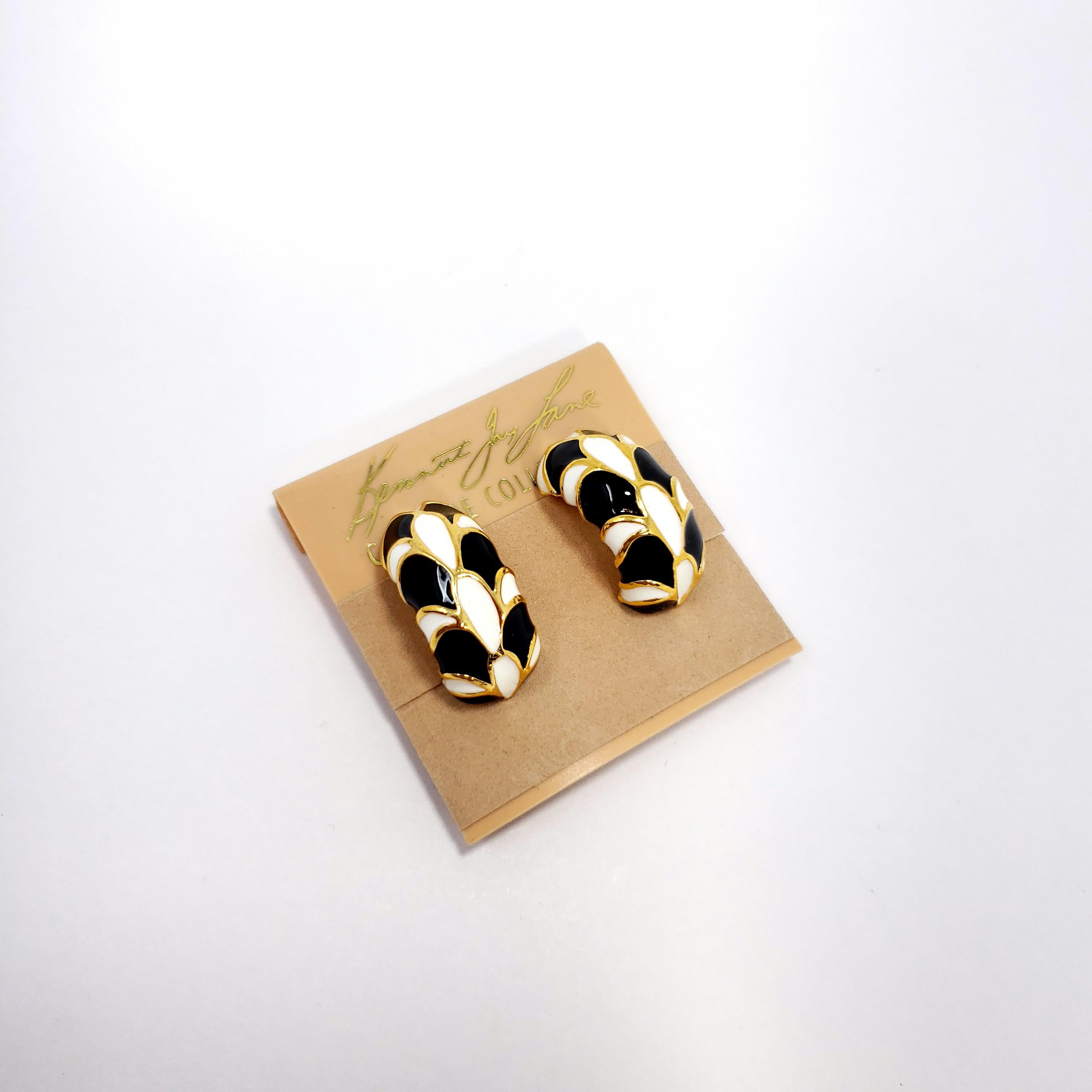 Stylish clip-on earrings by Kenneth Jay Lane! Each goldtone earring is painted with white and black enamel in a retro gold-outline pattern.

Hallmarks: KJL